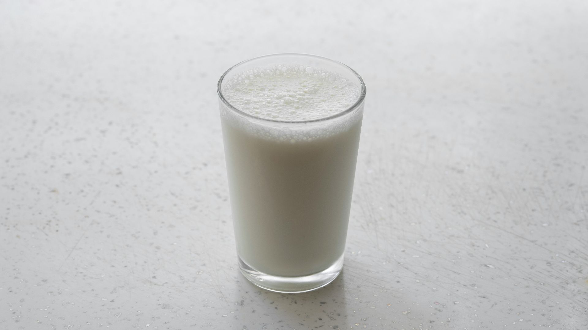 clear drinking glass with brown liquid