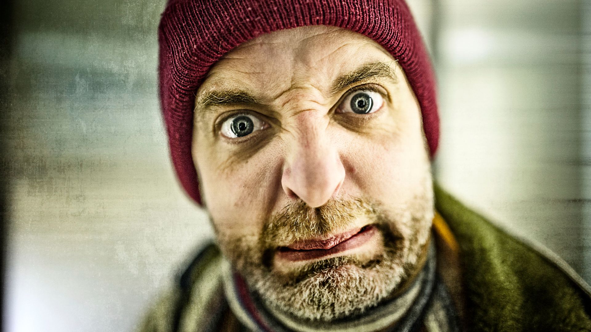 File:Man with beard and knit red cap frowns and has disgusted facial expression.jpg