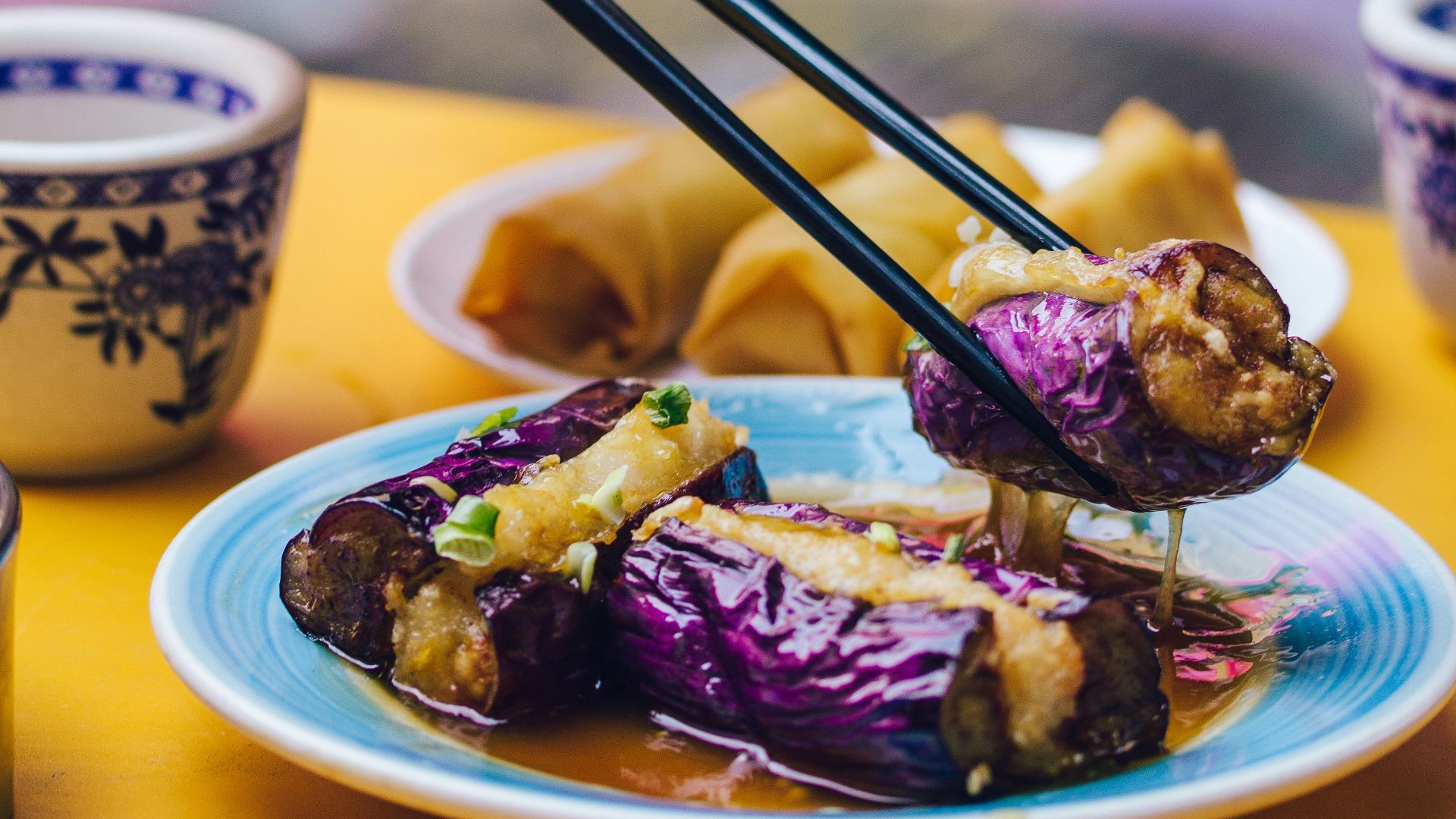 man eating food using chopsticks