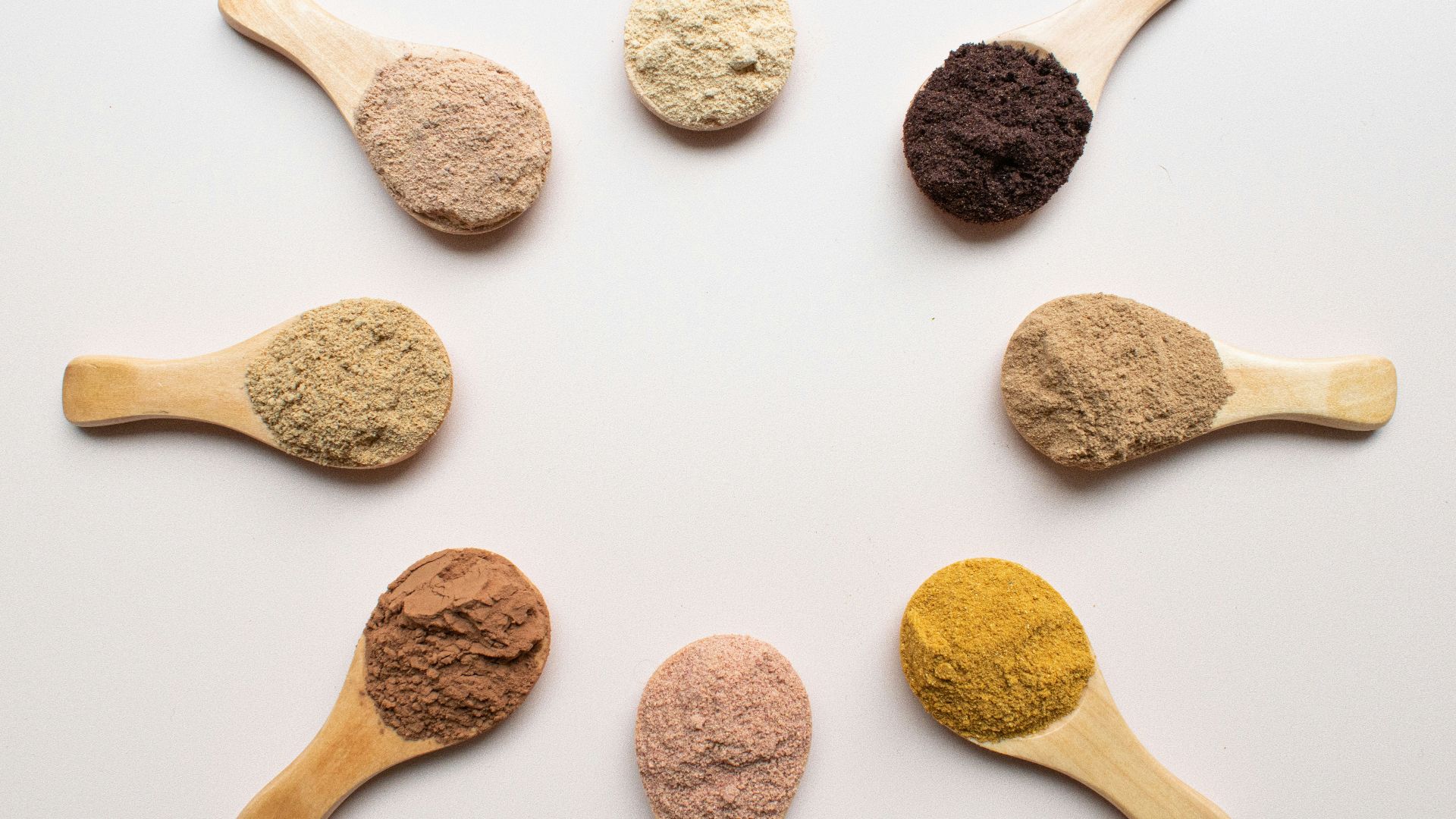 six different types of powdered spoons arranged in a circle