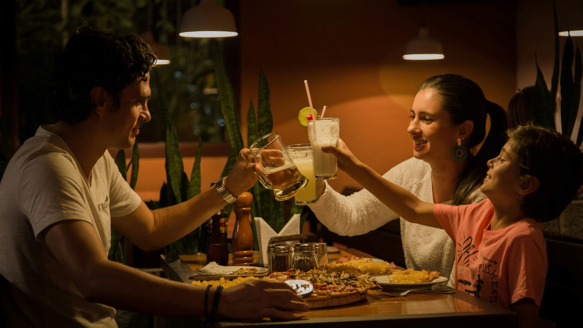 three people having a toast on table