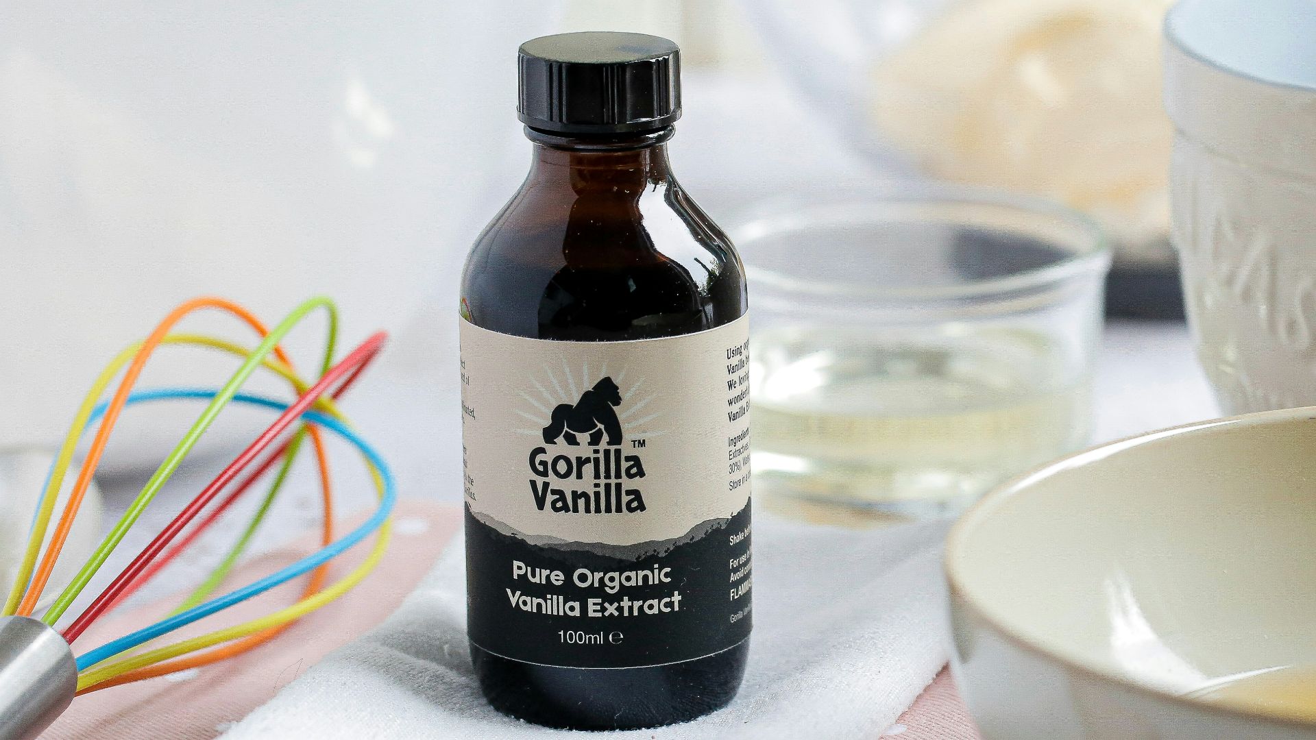 white ceramic bowl beside black glass bottle