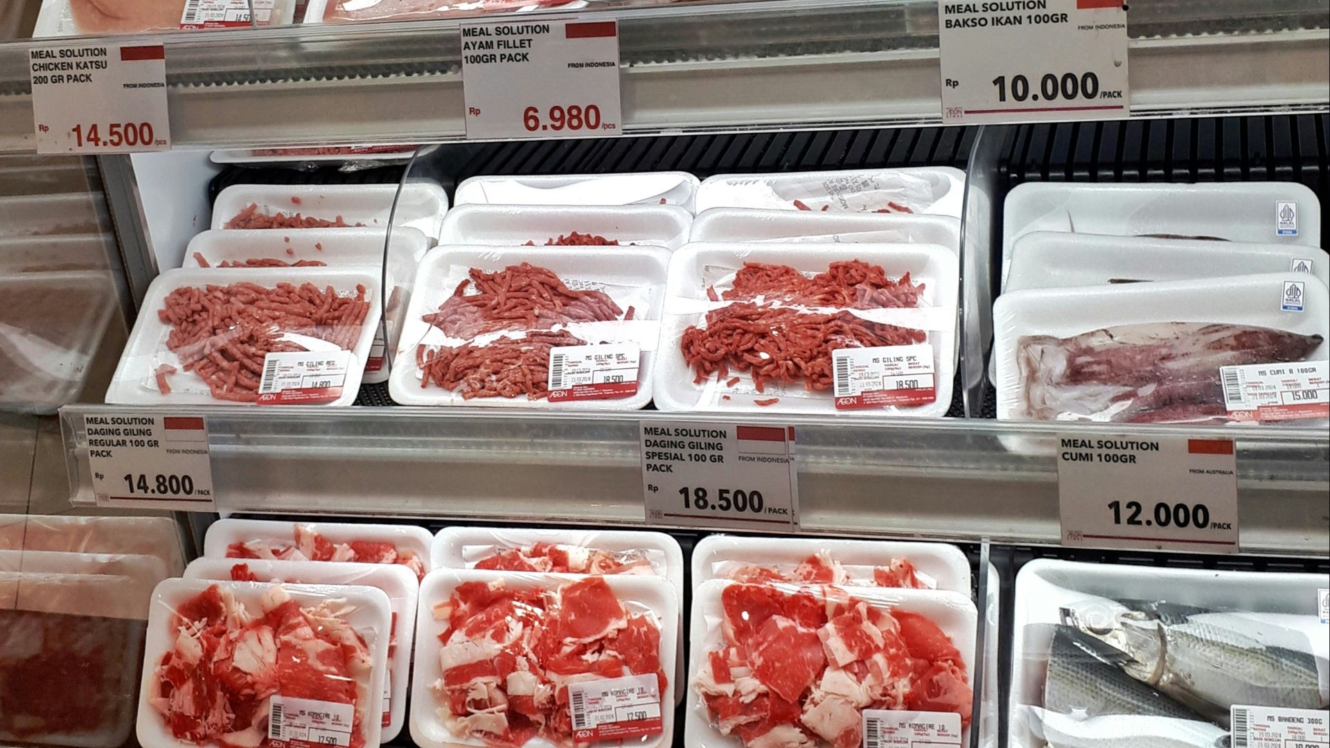 A display case filled with lots of different types of meat