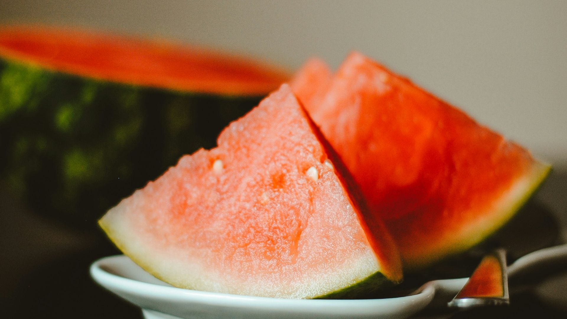 watermelon slice on white ceramic plate