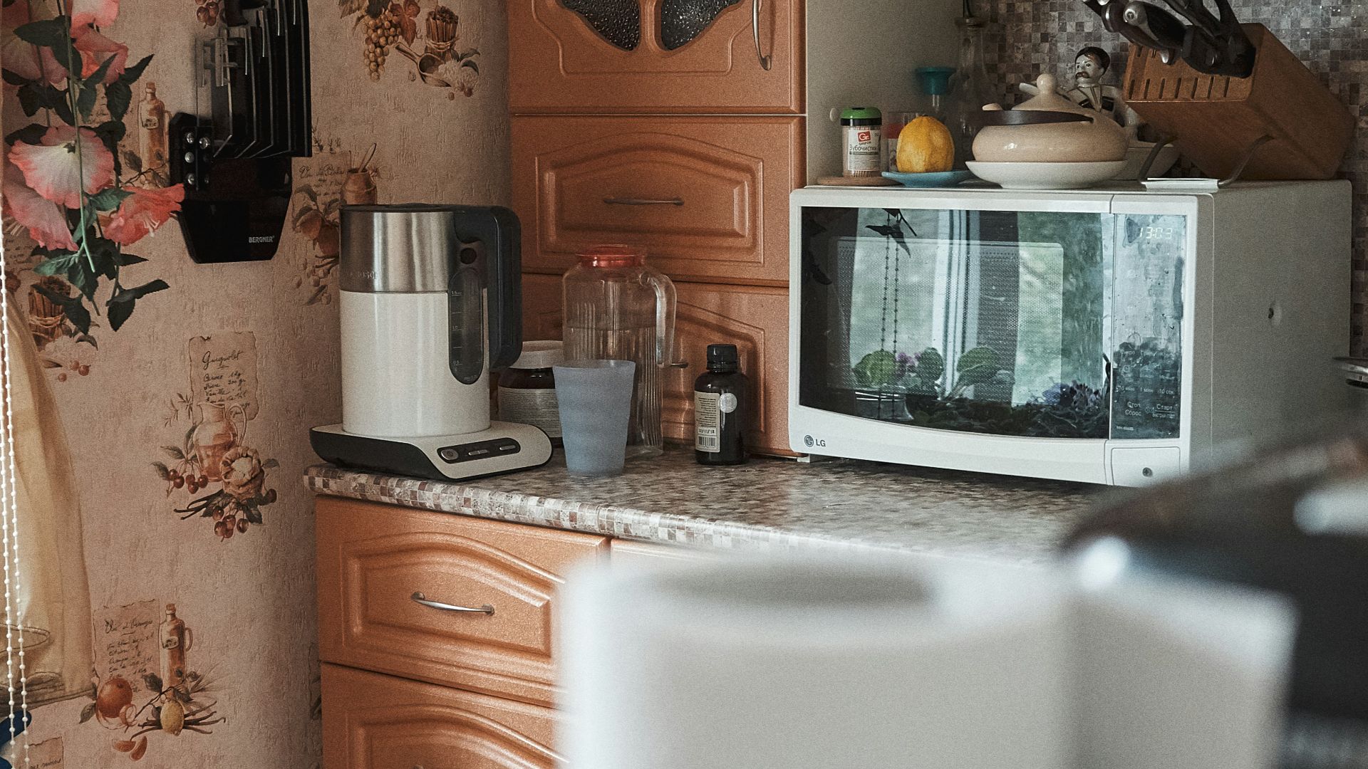 white microwave oven on brown wooden cabinet