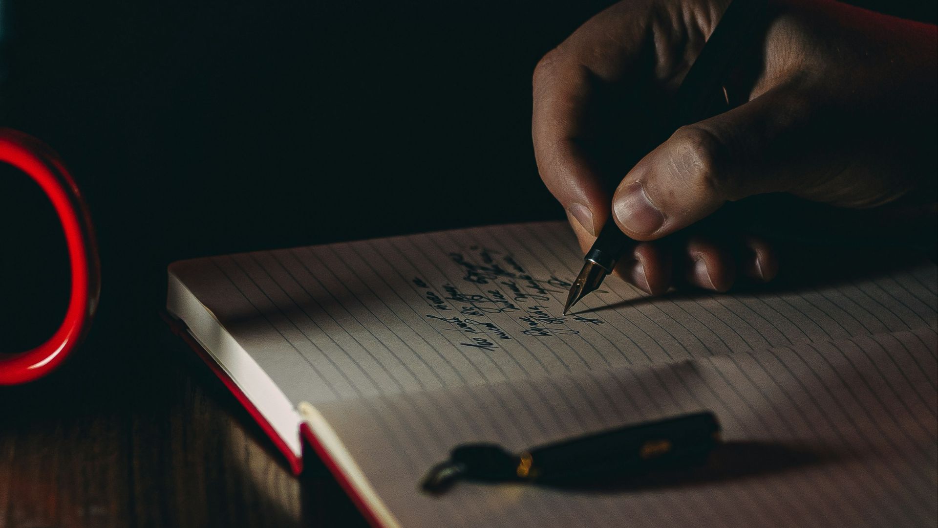 person writing on white paper