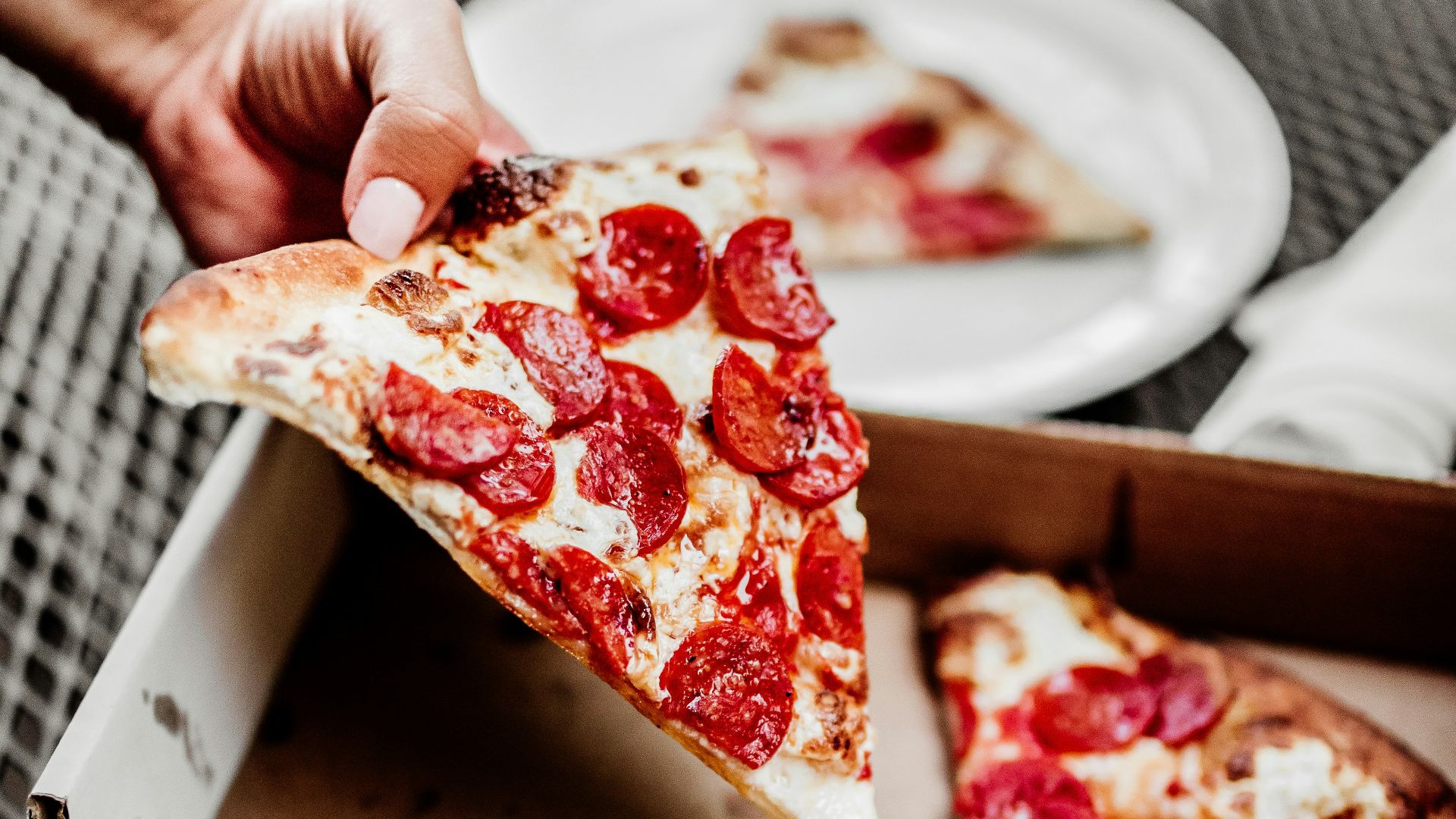 sliced pizza on white ceramic plate