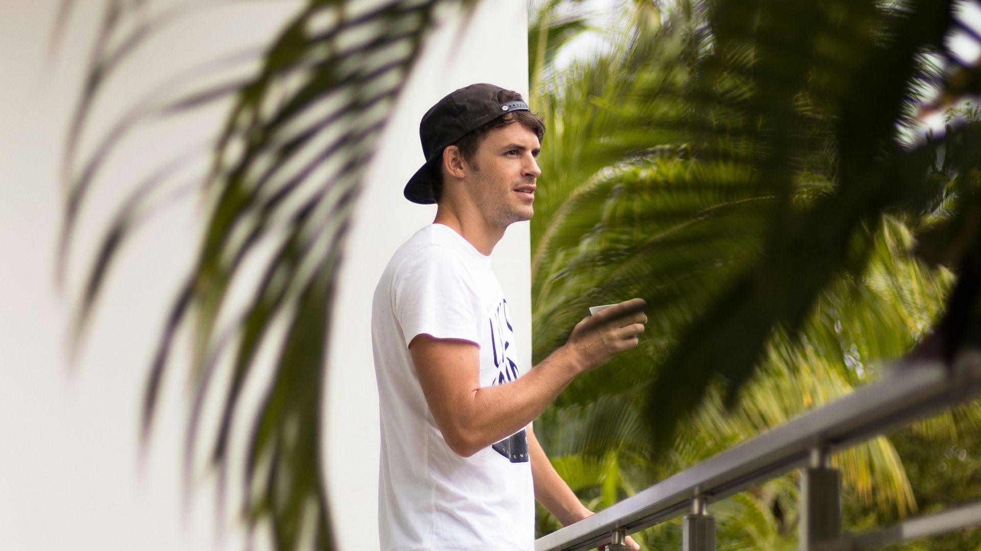 man standing near gray steel fence