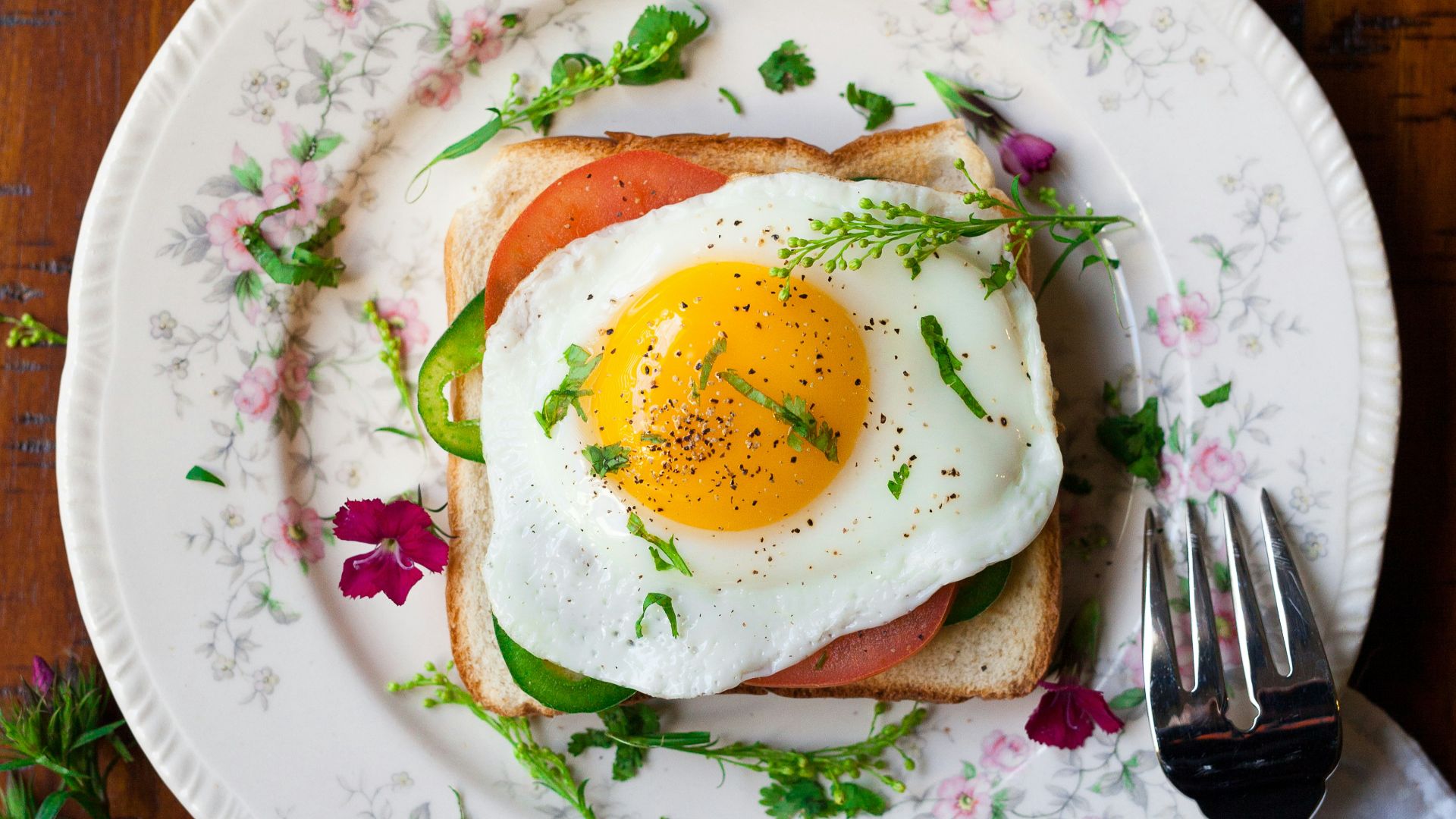 sunny-side up egg with bread beside fork