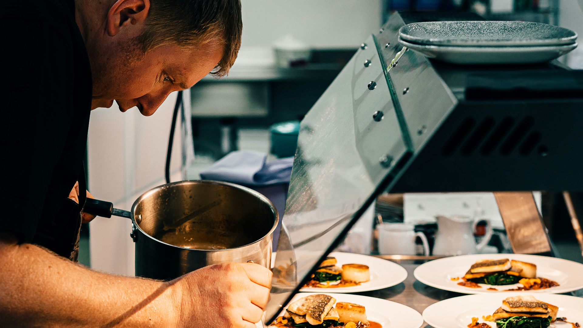 man in black t-shirt holding stainless steel bowl