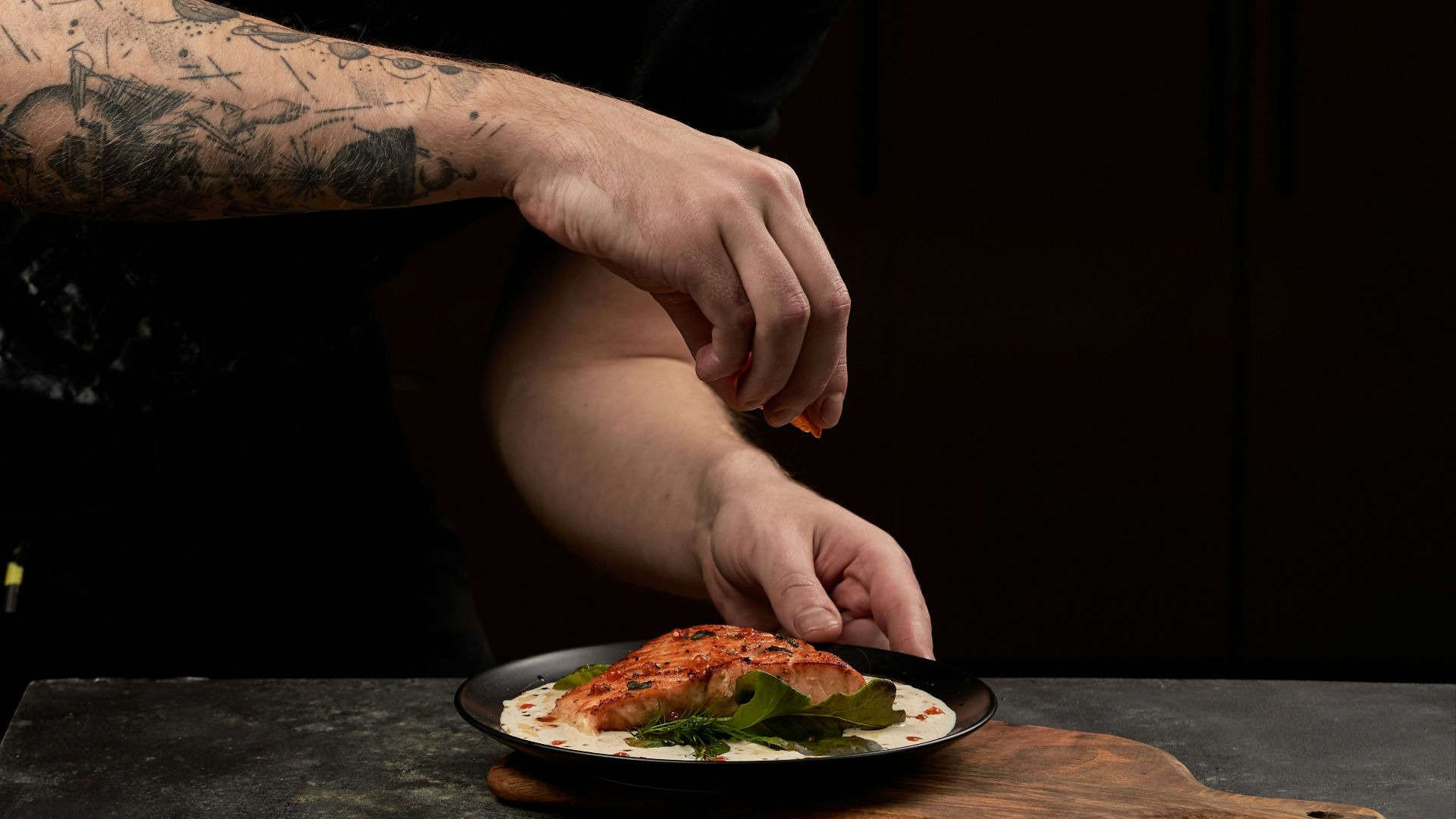 man in black crew neck t-shirt eating