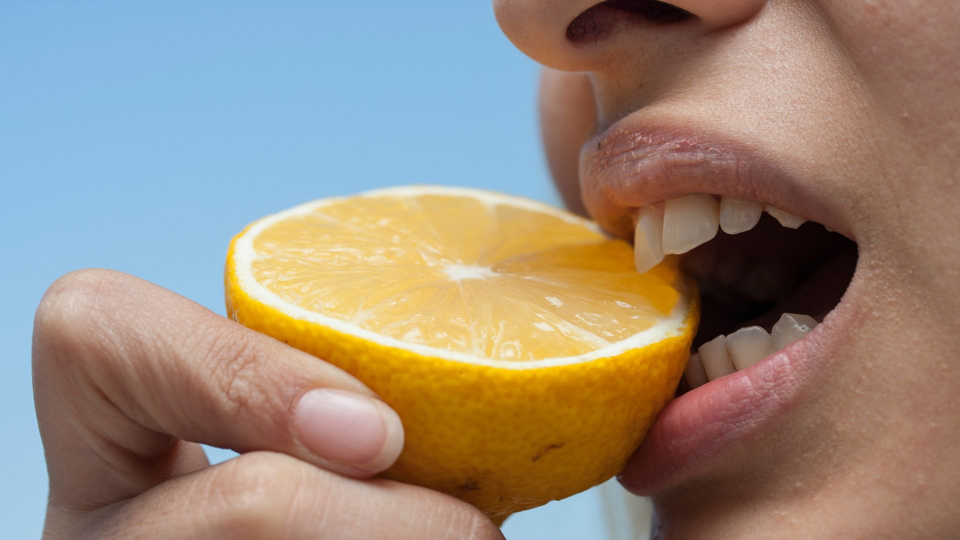 person holding orange fruit during daytime