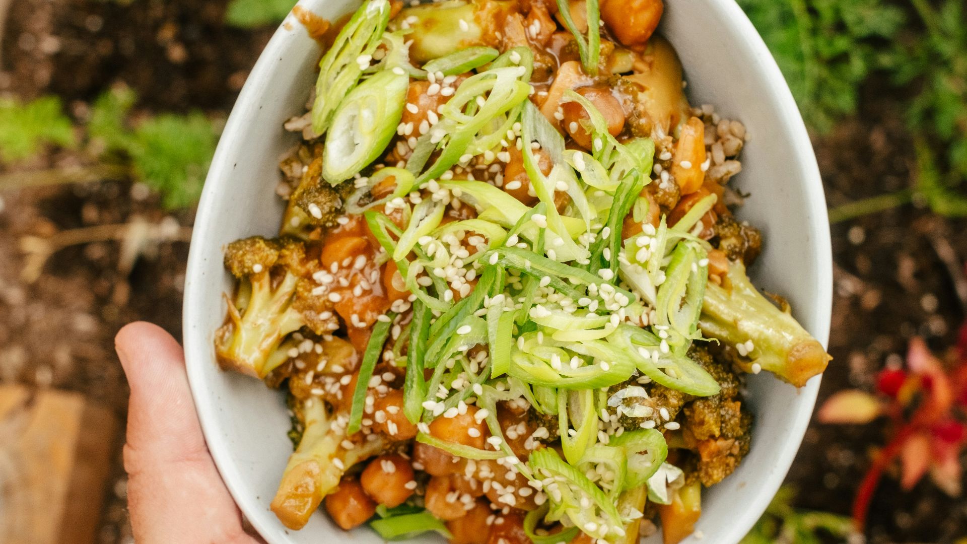 A person holding a bowl of food in their hand