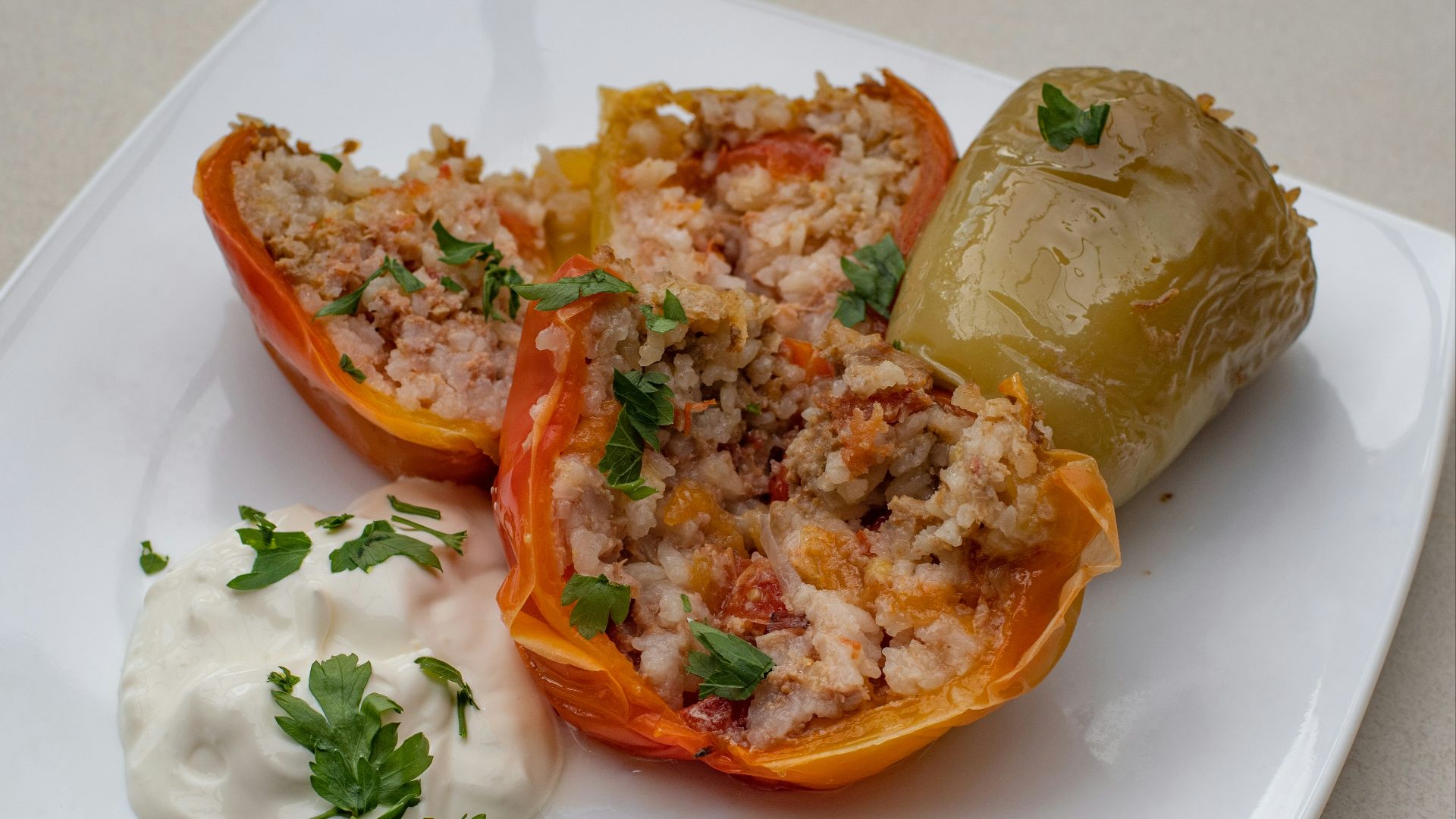 a white plate topped with stuffed bell peppers
