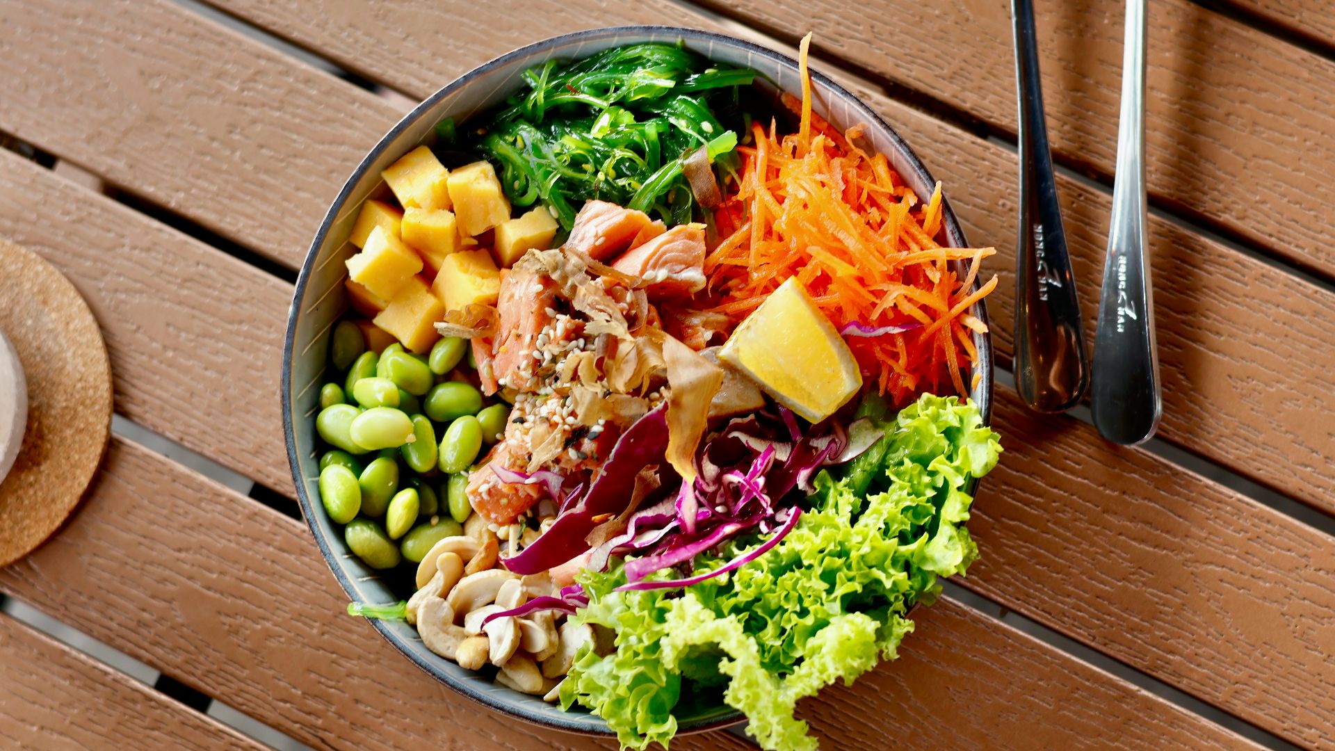 a bowl of food sitting on a wooden table