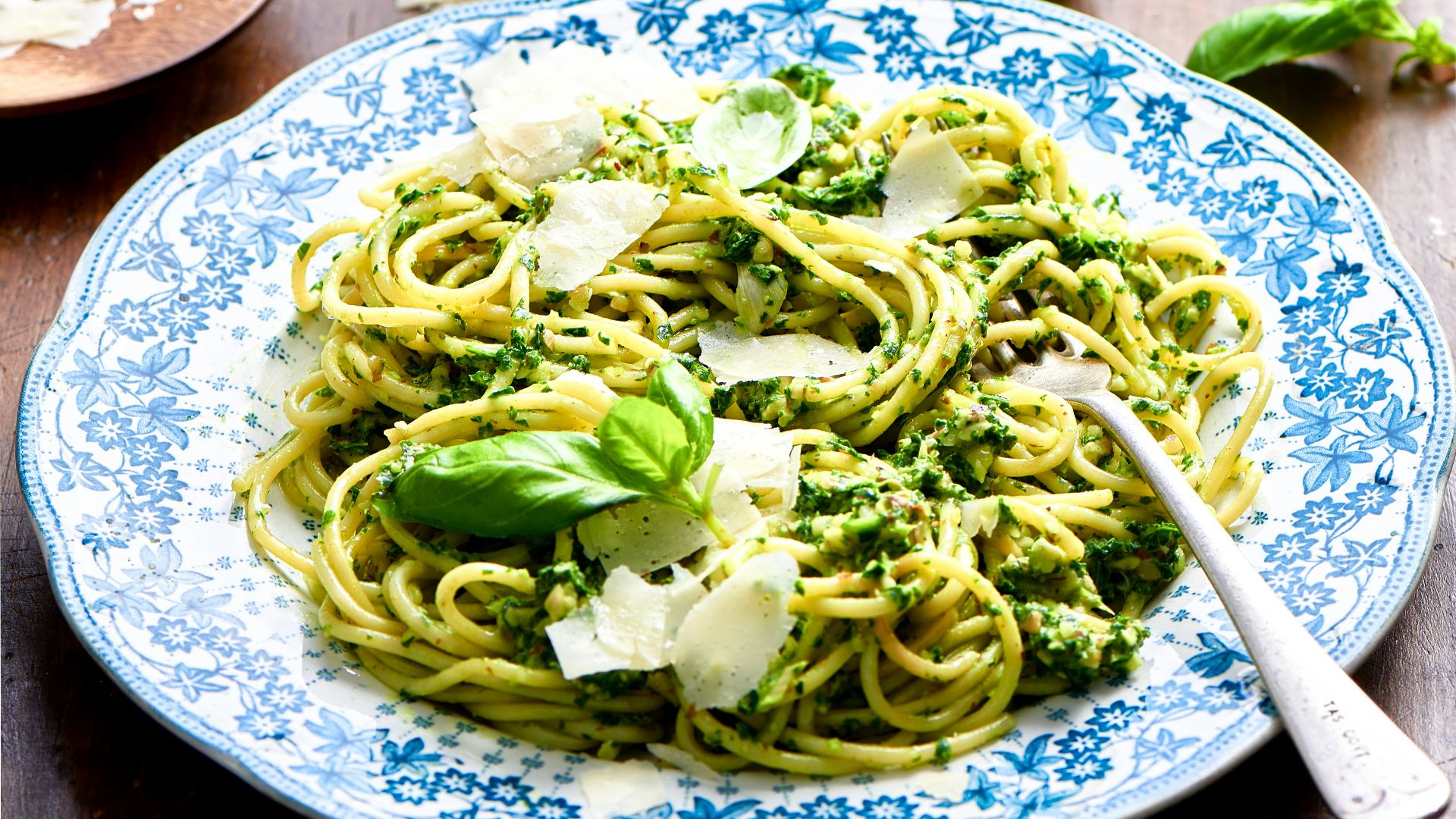 a plate of pasta with broccoli and parmesan cheese
