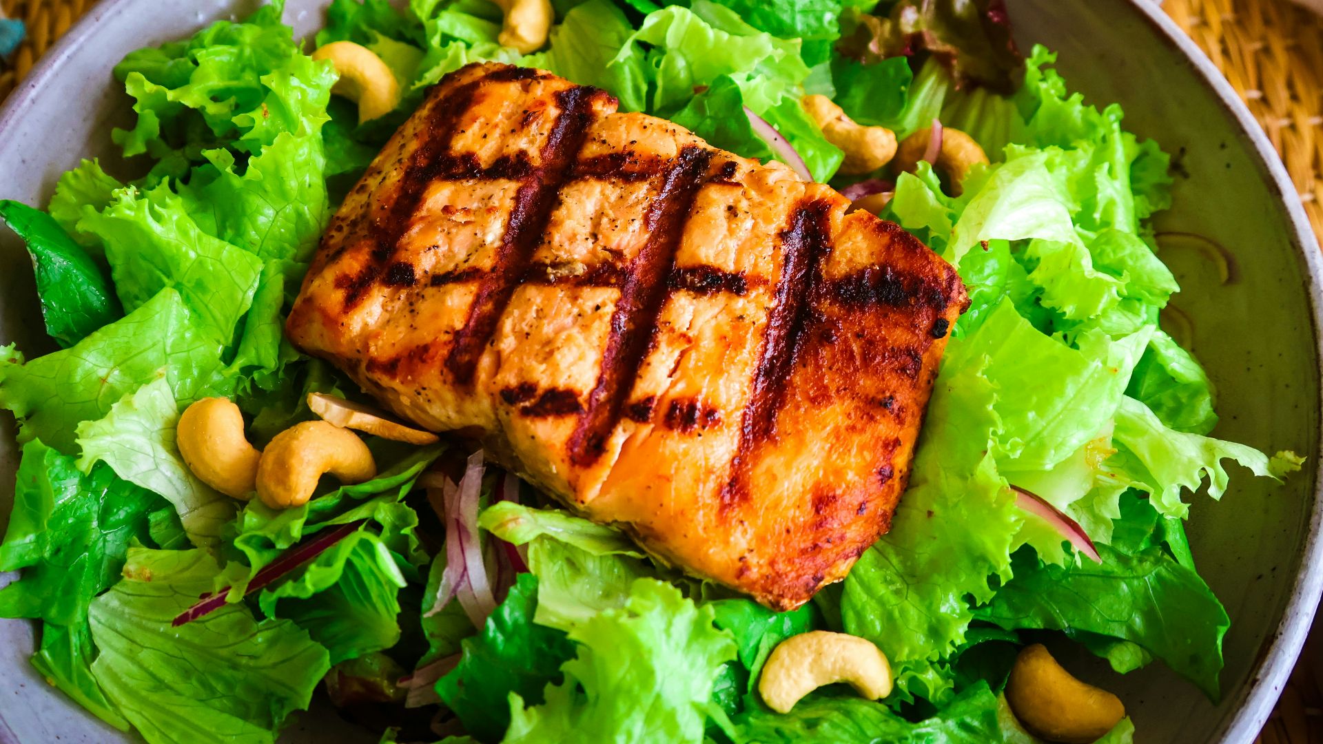 Grilled salmon salad with cashews.