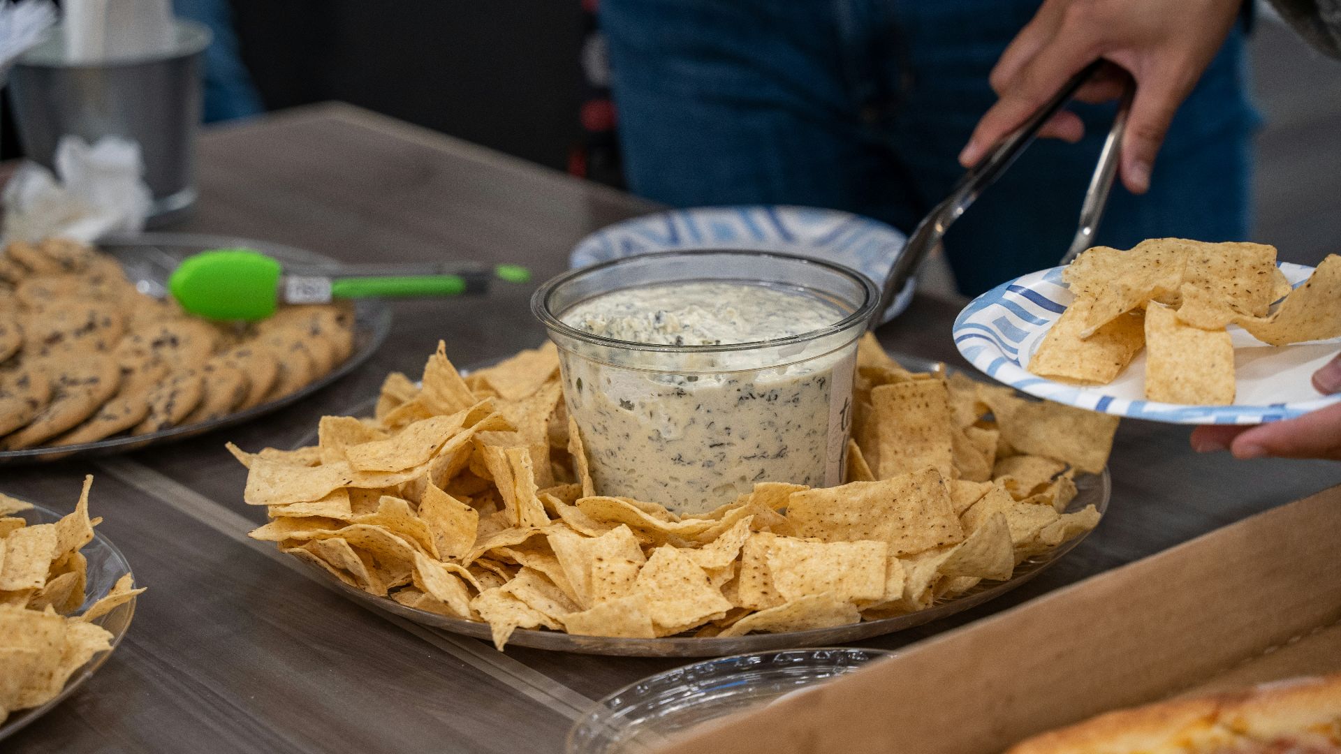 a person cutting a cake