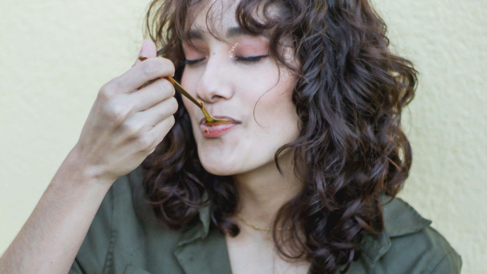 a woman holding a pink bowl of food