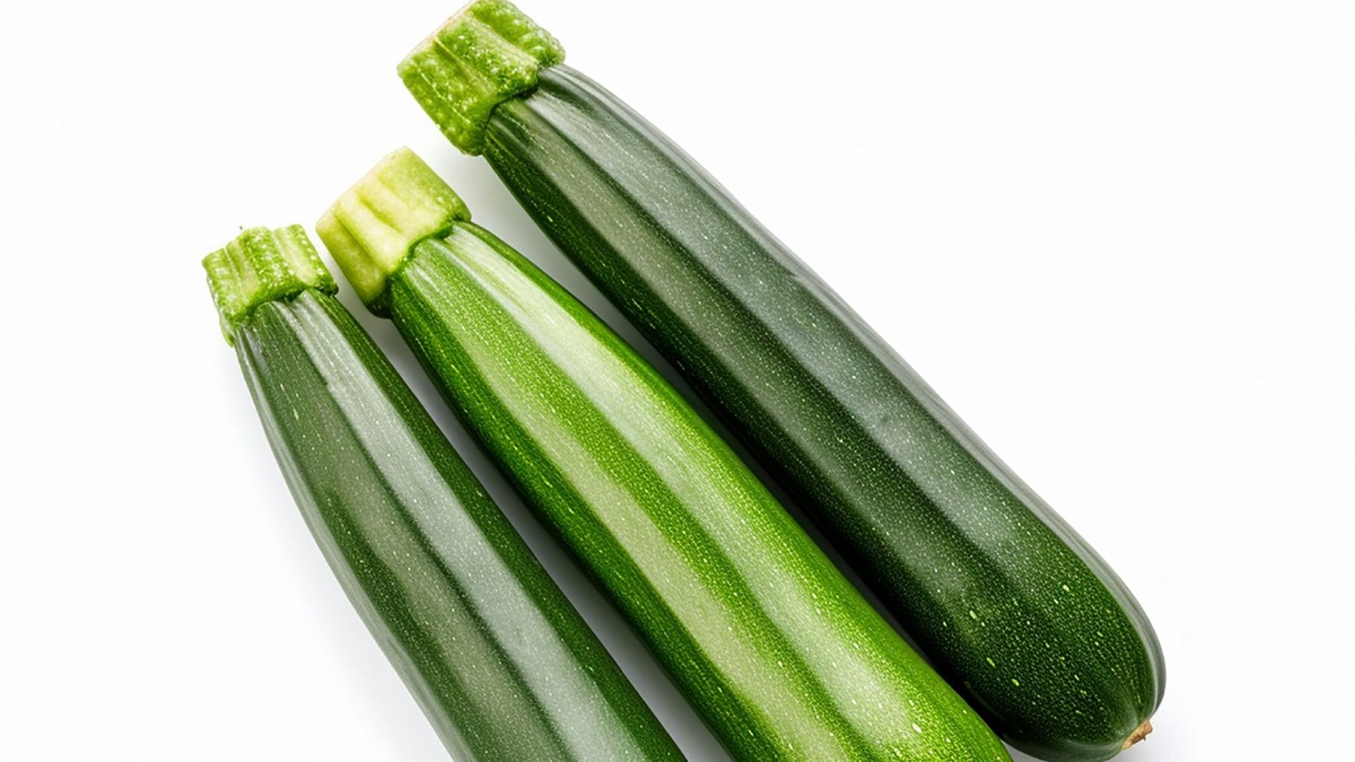 three green cucumbers on a white background