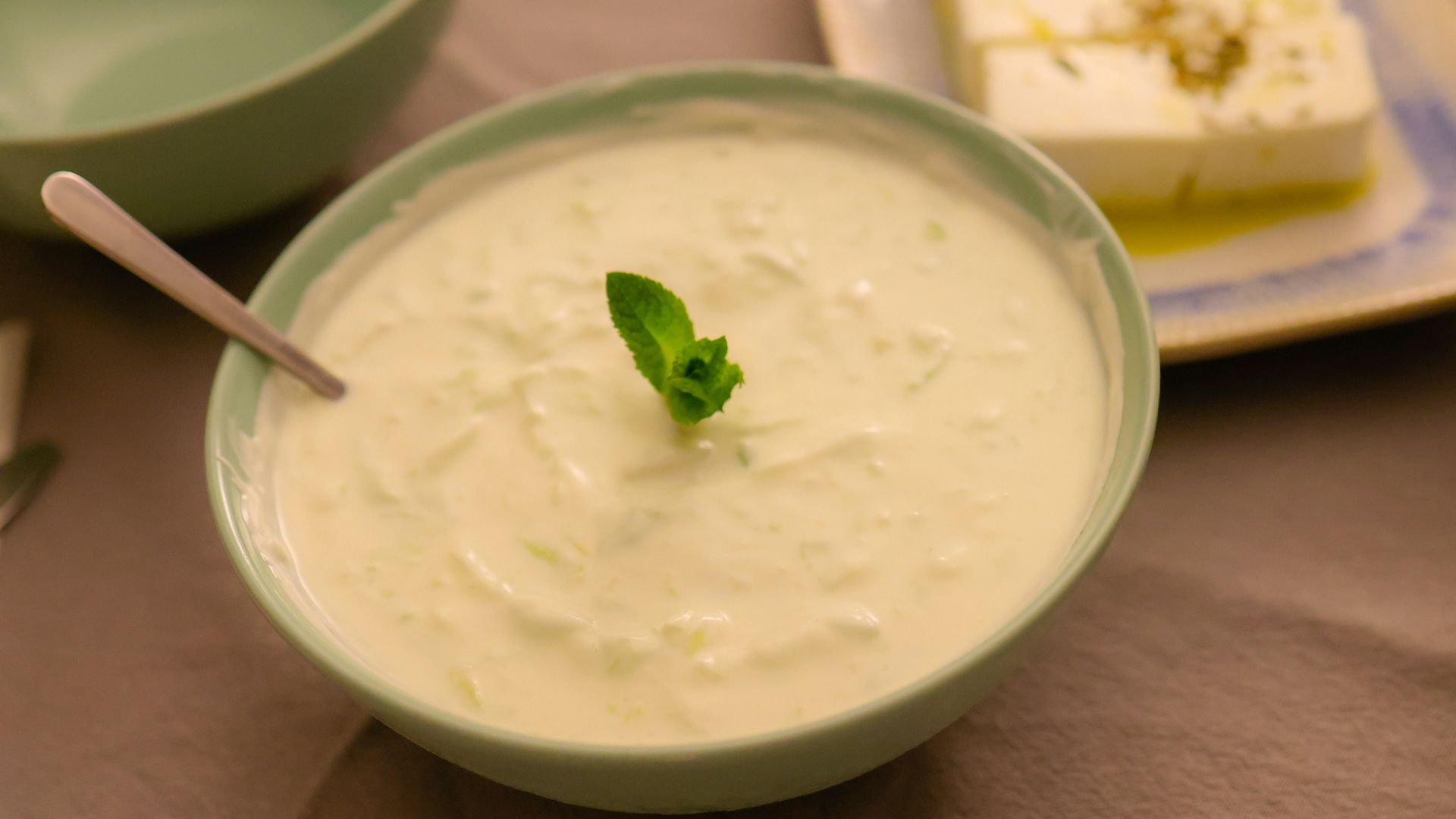a table topped with bowls of food and a plate of cake