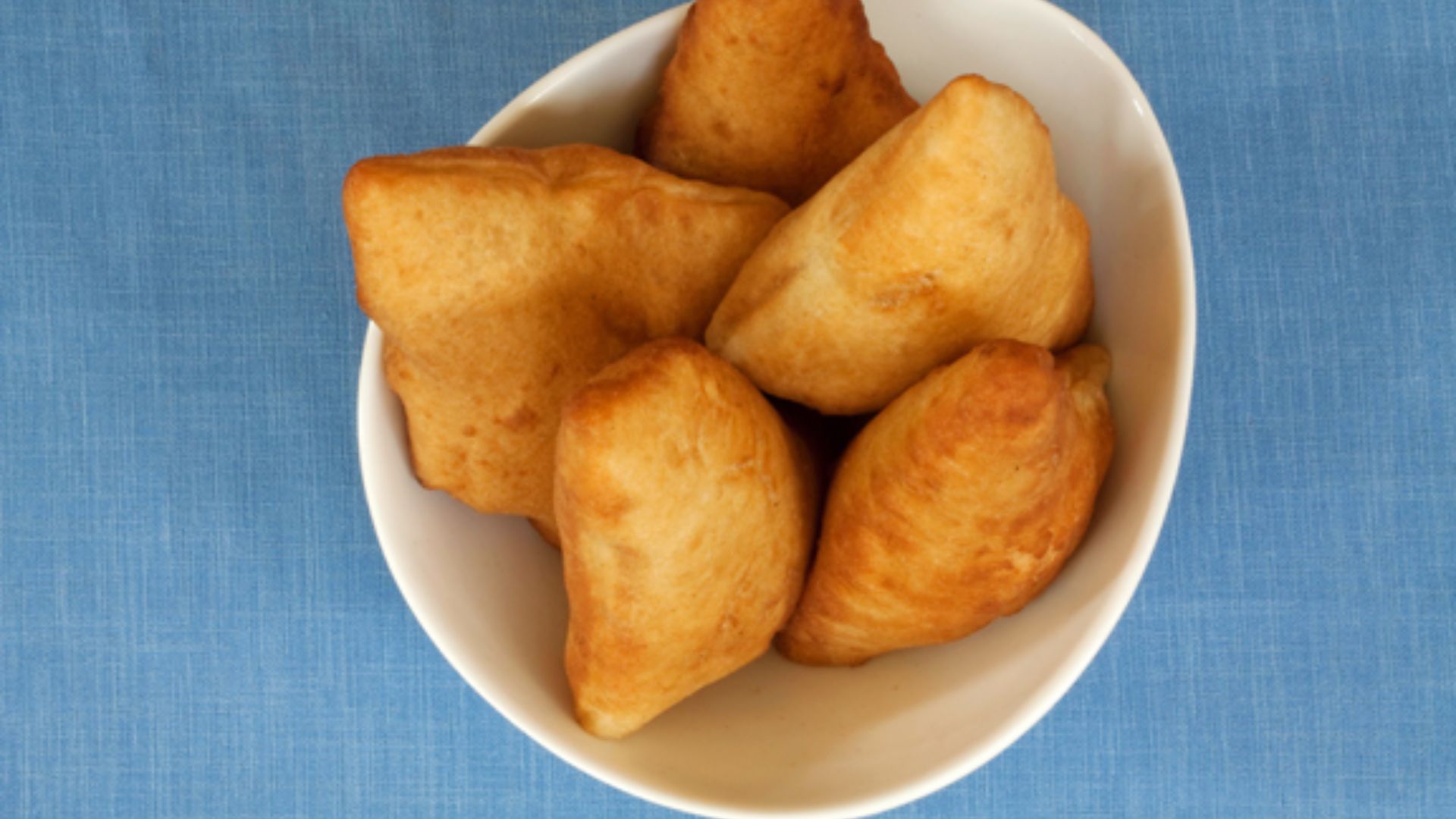 File:Bowl of mandazi.jpg