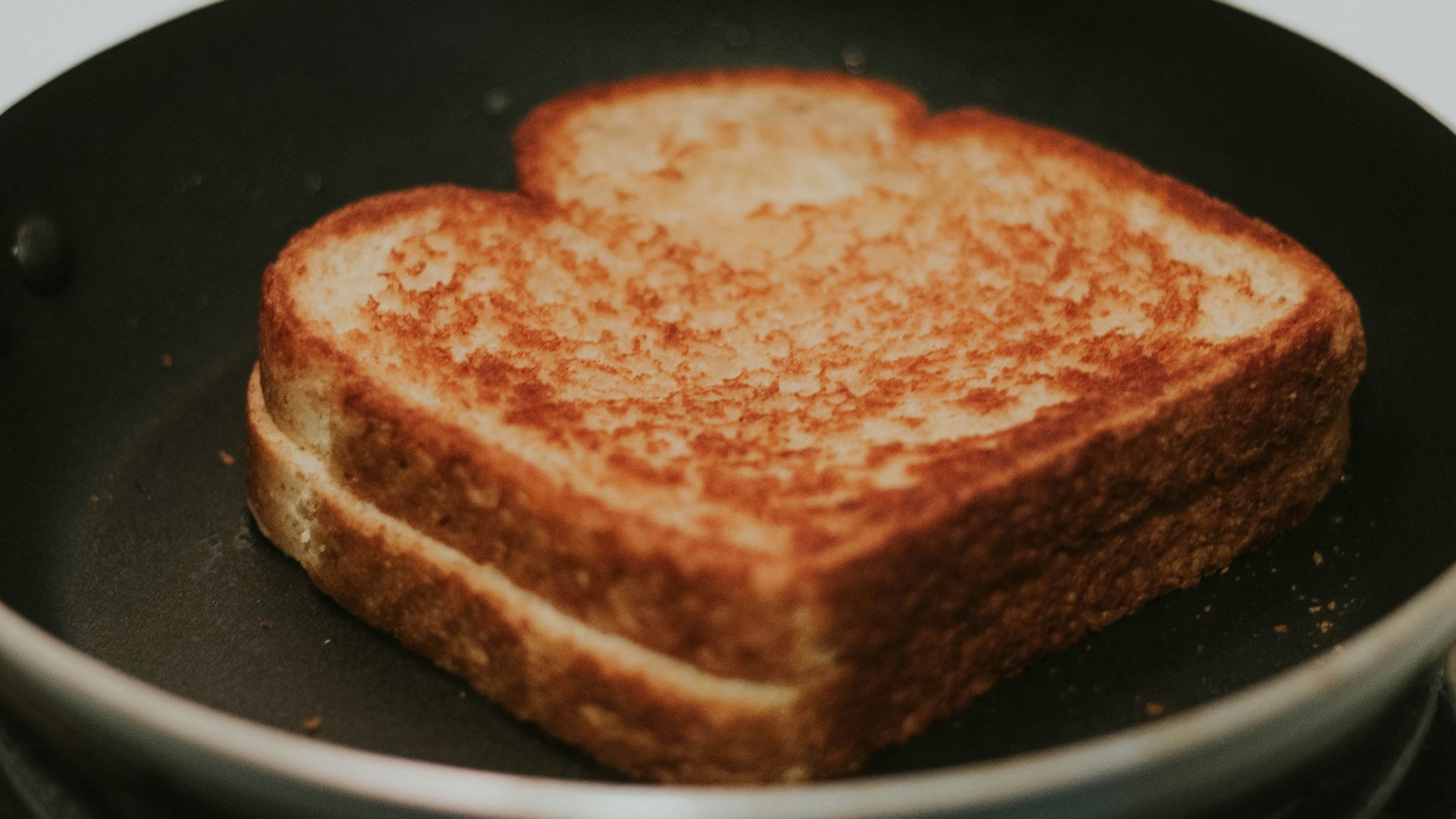 a toasted sandwich in a frying pan on a stove