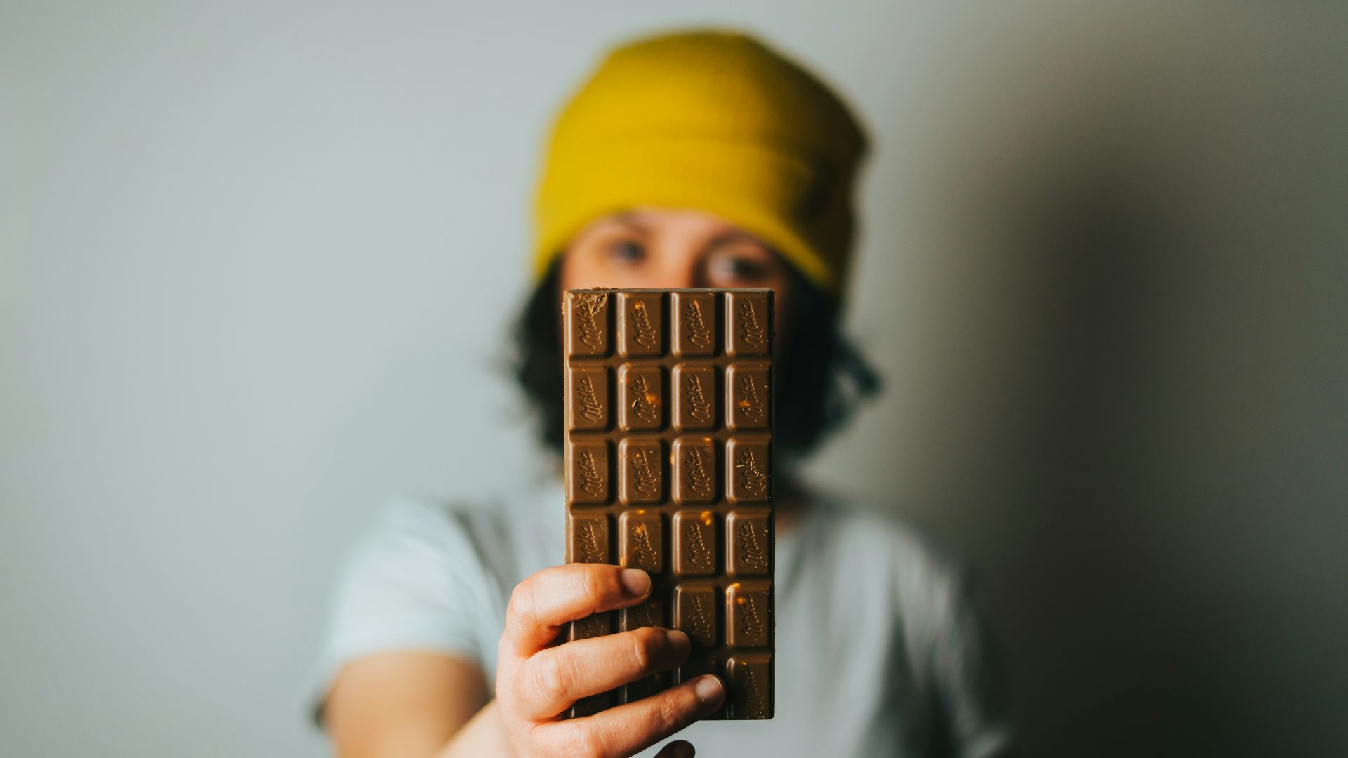 person holding brown cone with yellow cap