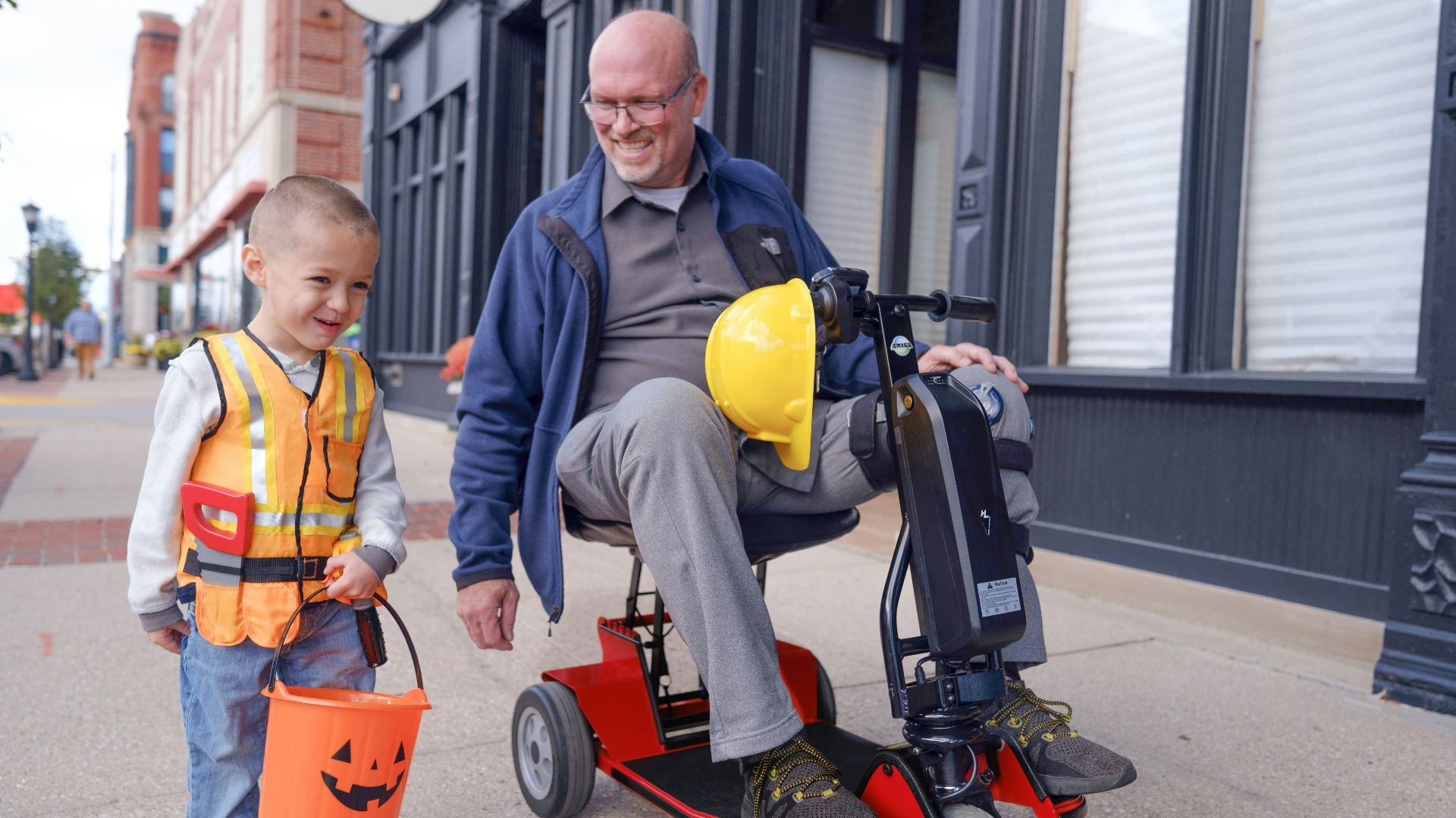 an older man and a young boy on a scooter