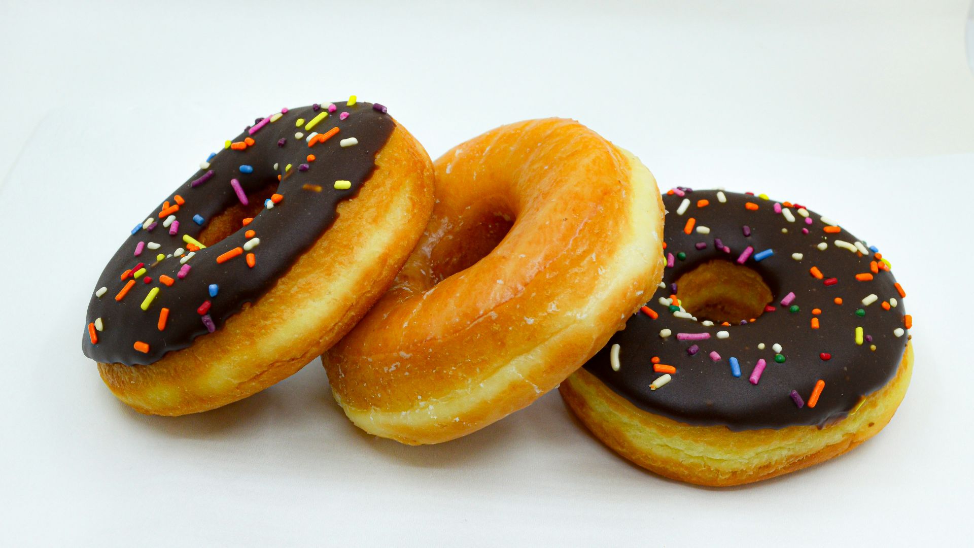 brown donuts with white cream on top