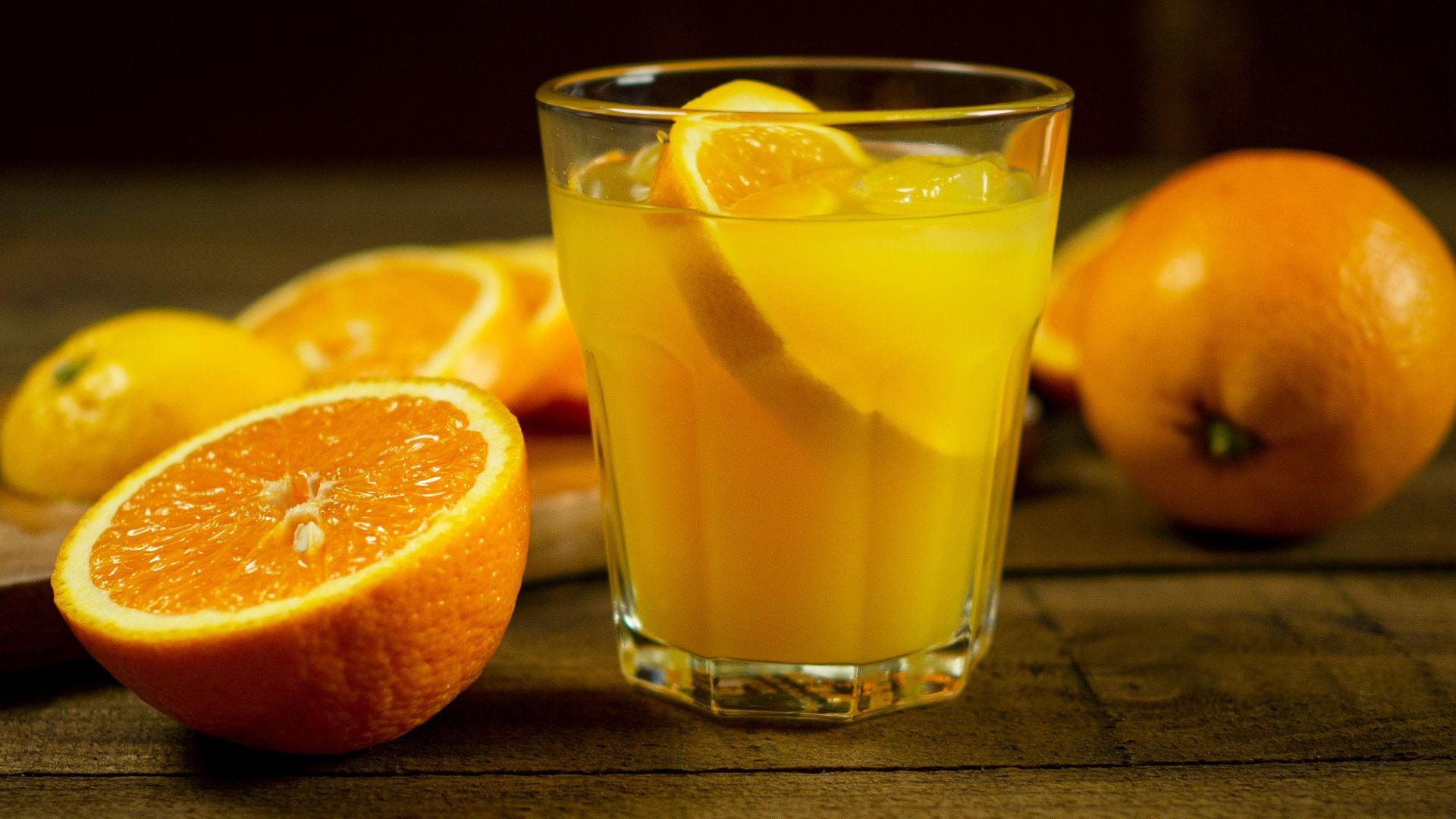 orange juice in clear drinking glass