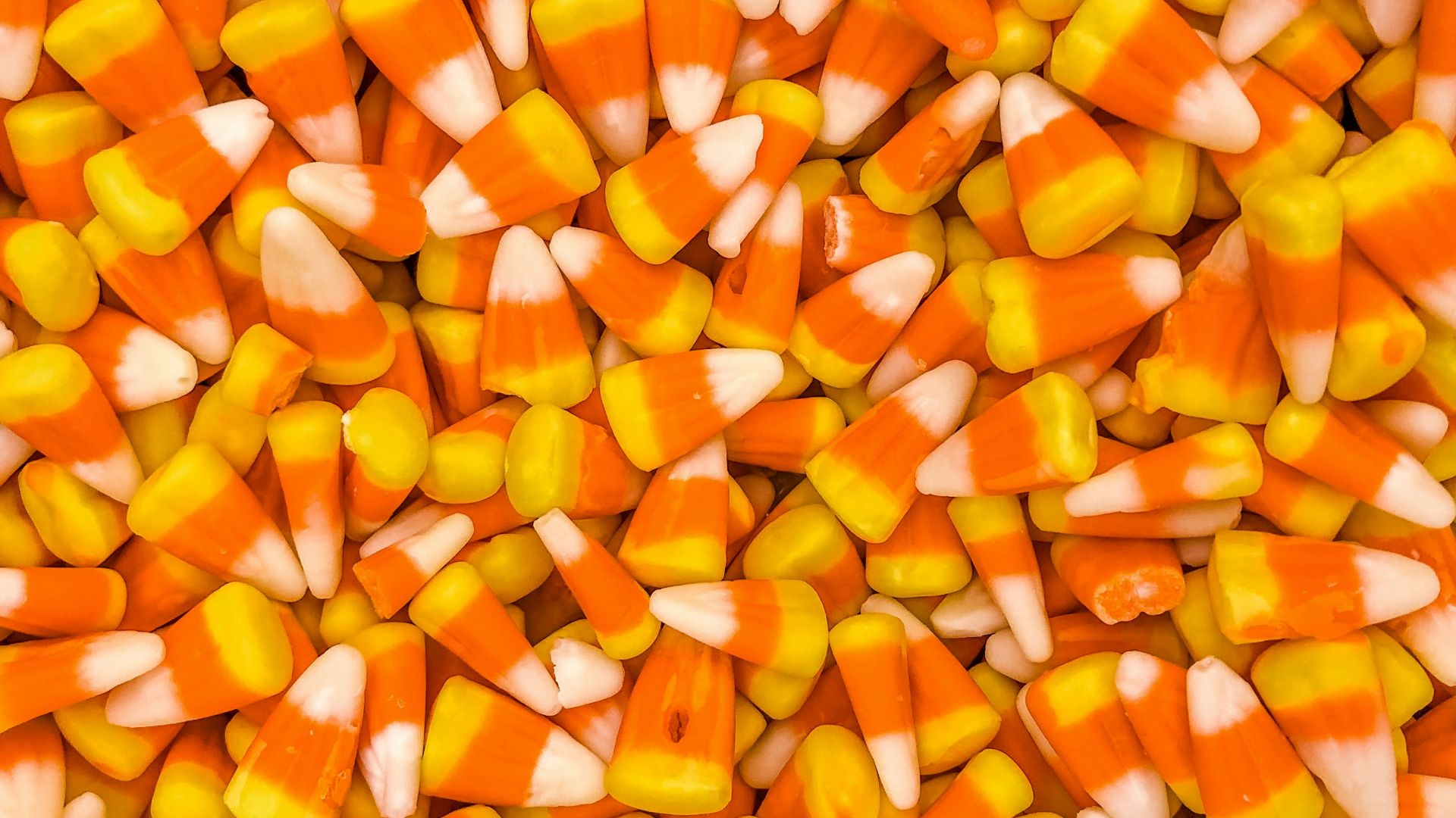 a pile of orange and white candy corn