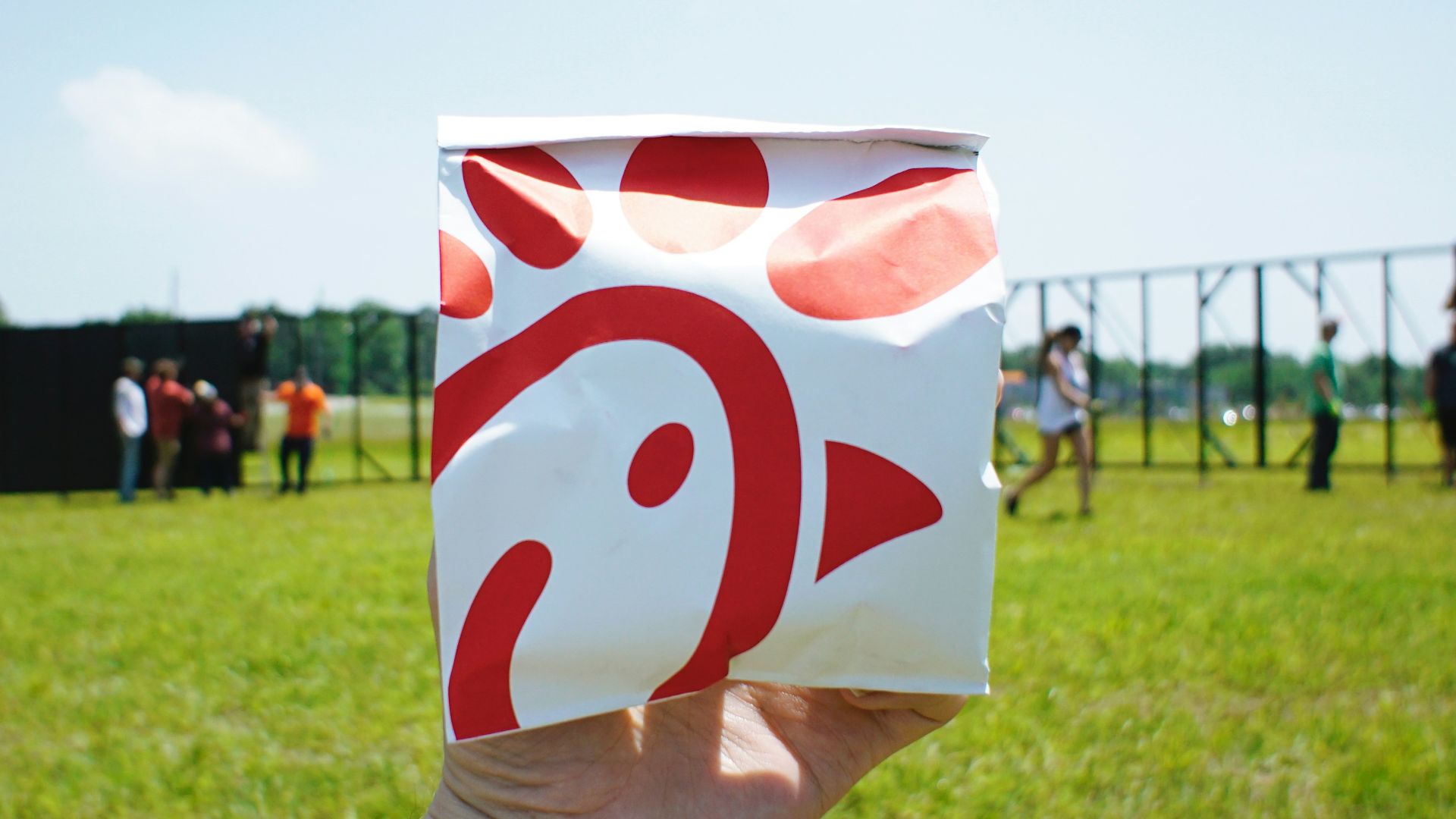 person holding white and red box