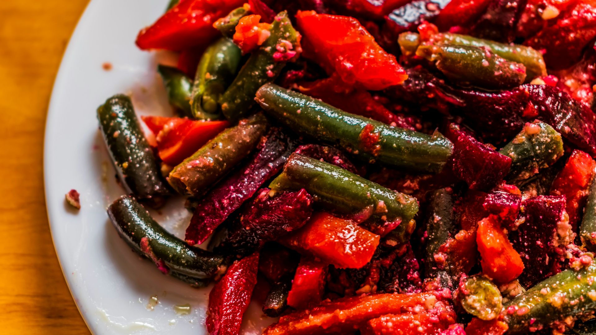 a white plate topped with red and green vegetables