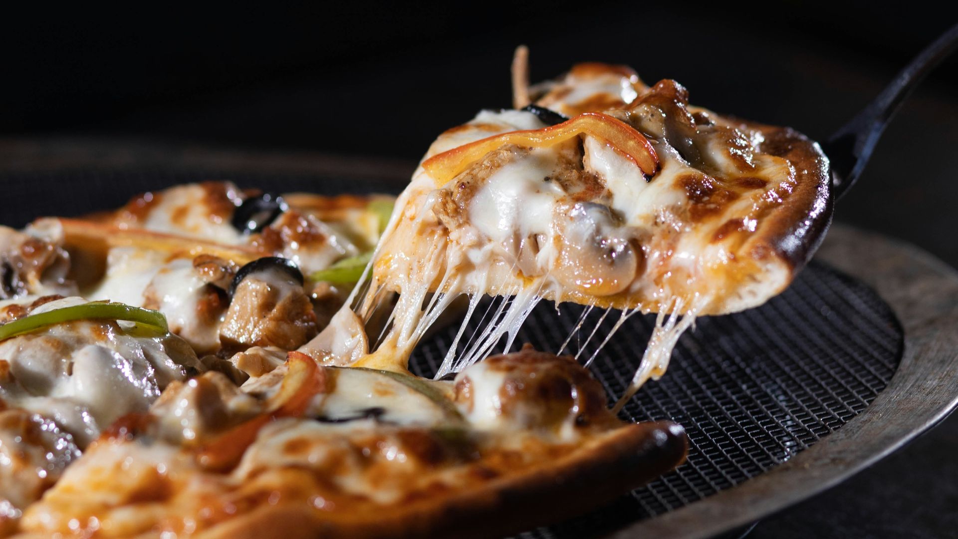 a slice of pizza is being lifted with a spatula