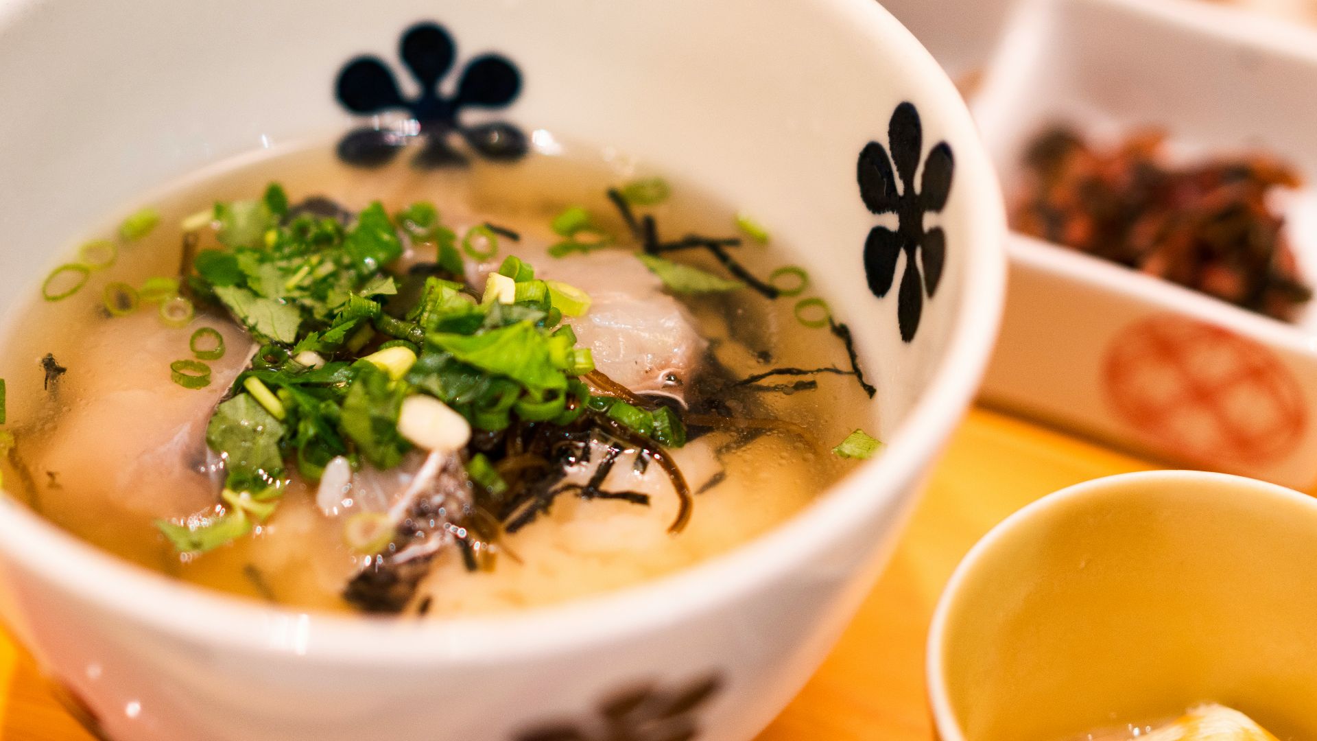 white and blue ceramic bowl with soup