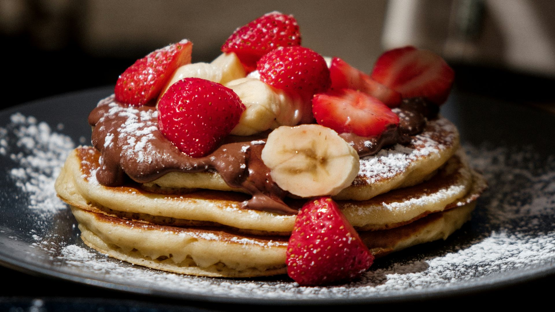 pancakes with strawberries and blueberries on top