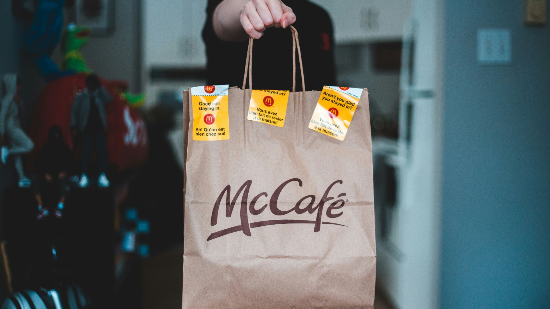 person holding white and brown paper bag
