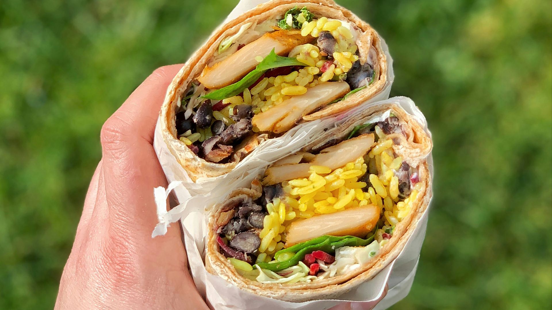 person holding a white and brown cake