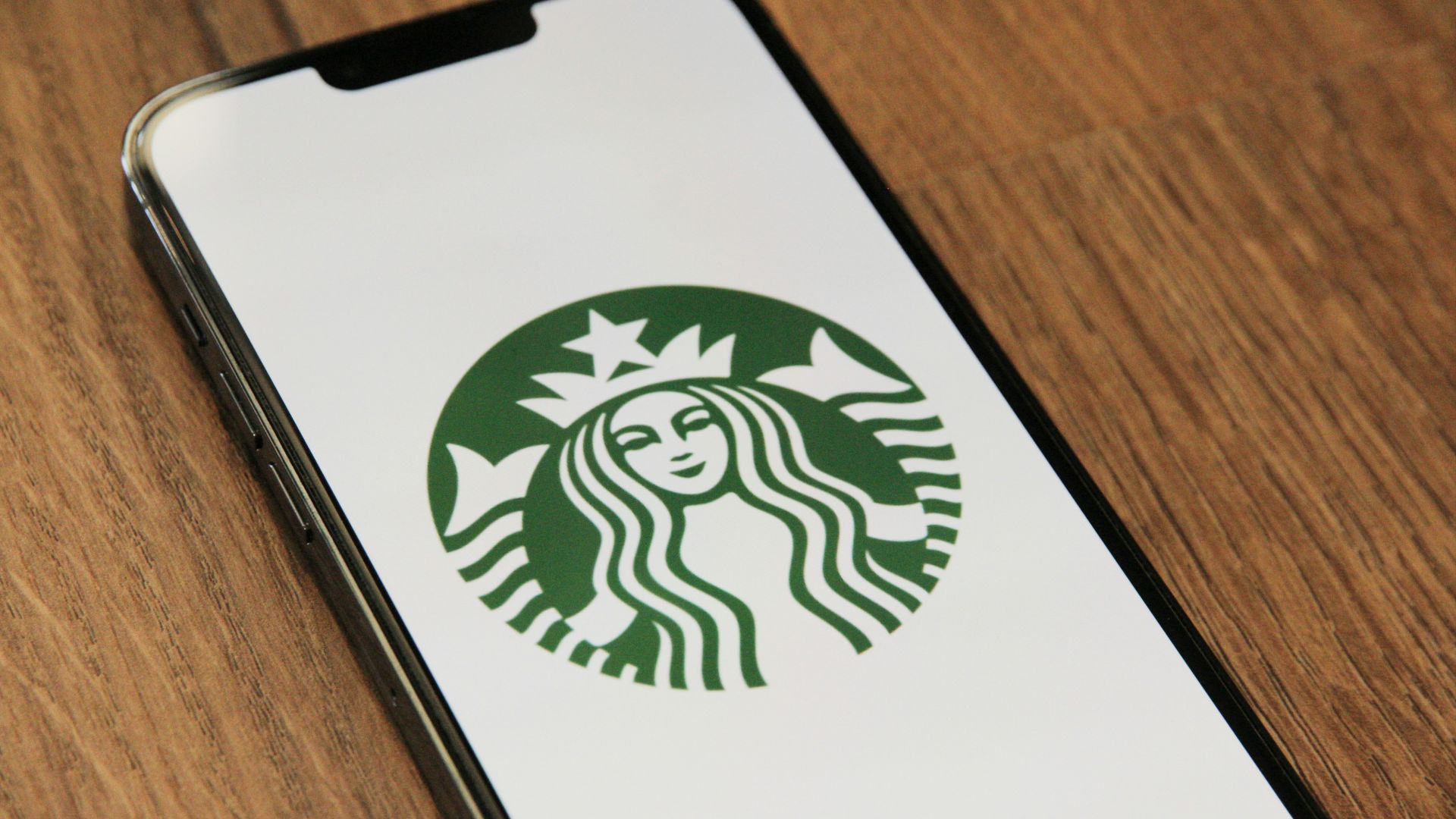 a close up of a cell phone with a starbucks logo on it