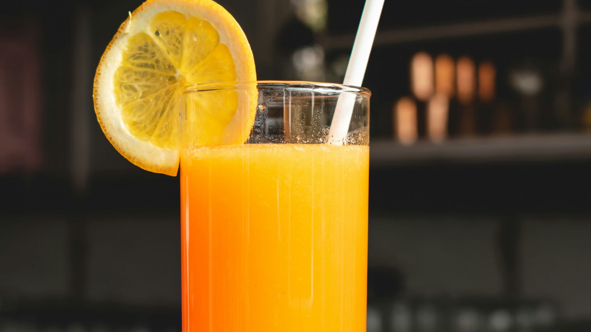 orange juice in clear drinking glass