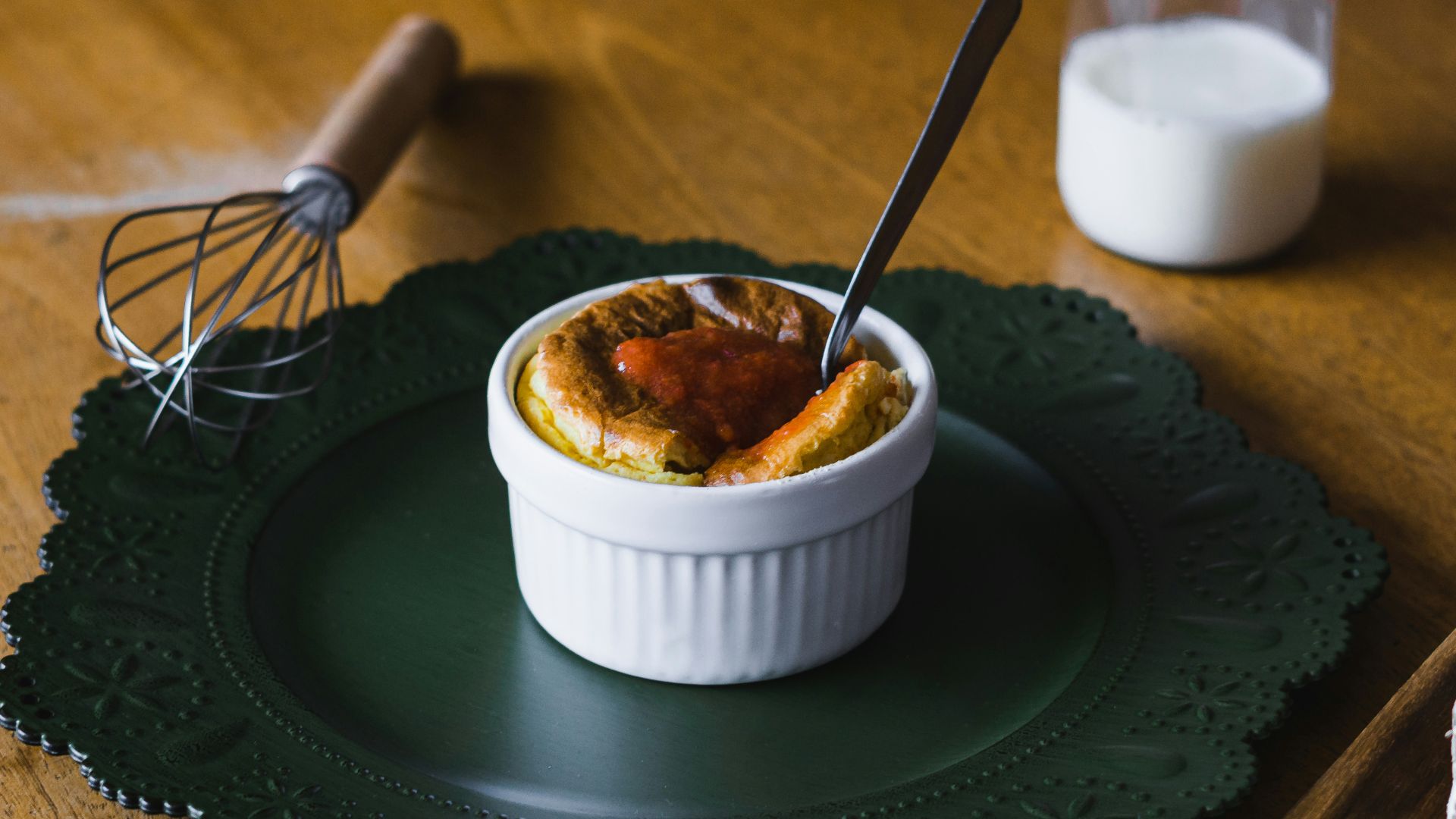 white ceramic bowl with stainless steel spoon on green round plate