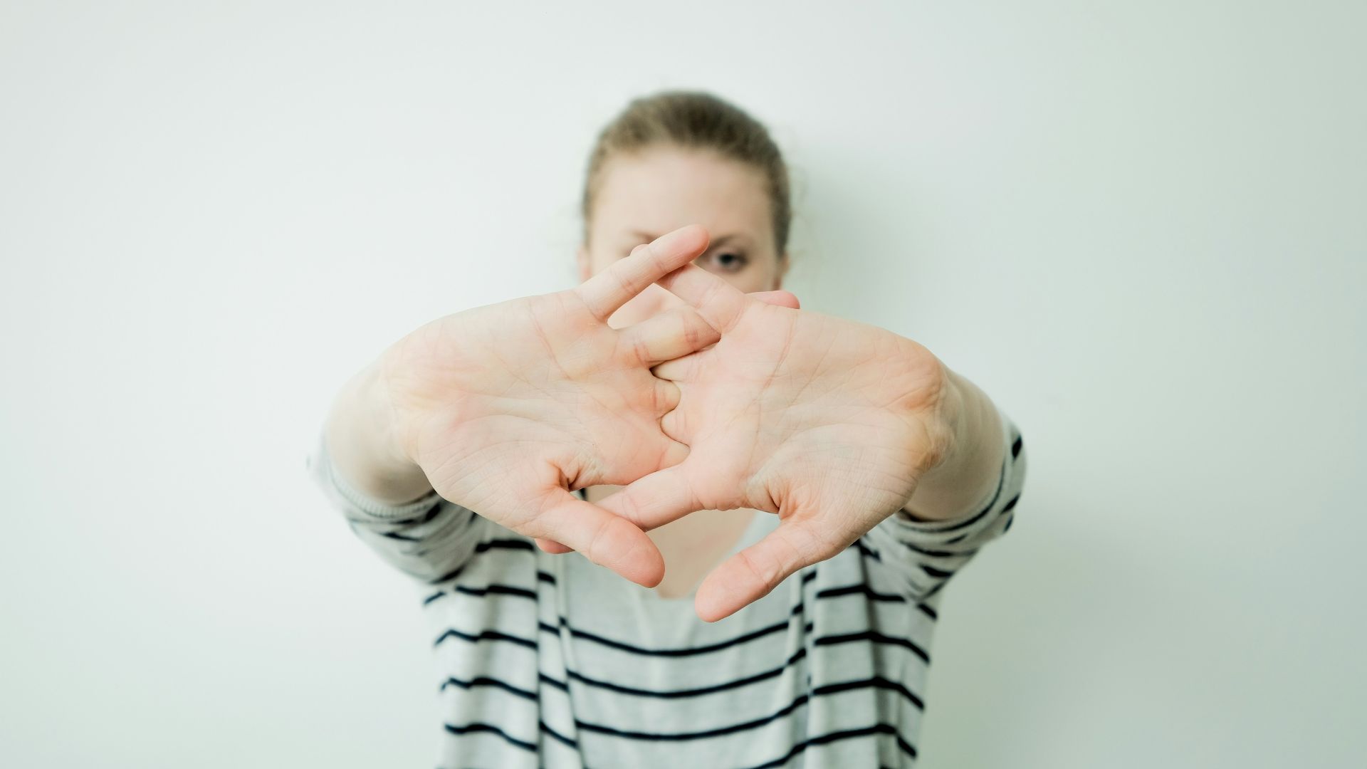 a woman making a heart with her hands
