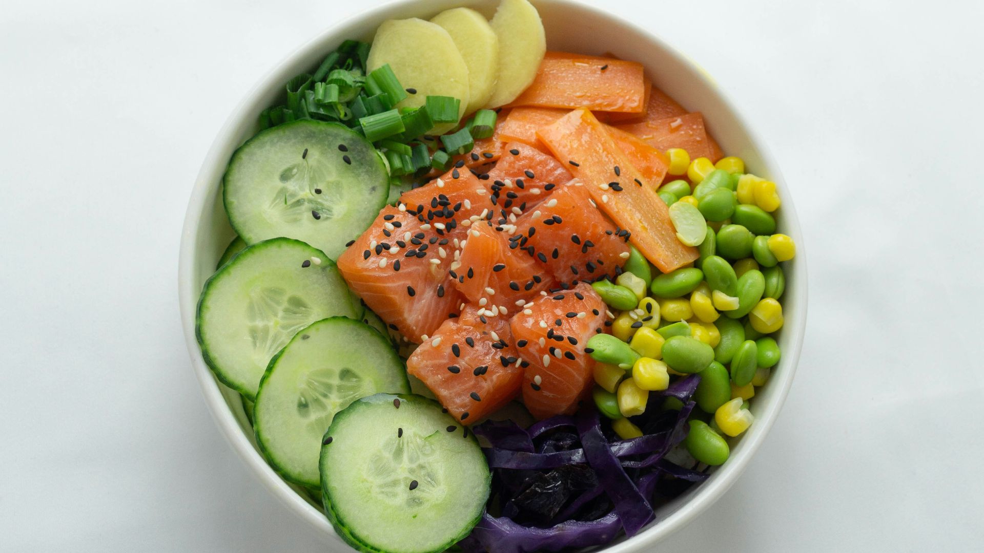 sliced cucumber and cucumber on white ceramic bowl