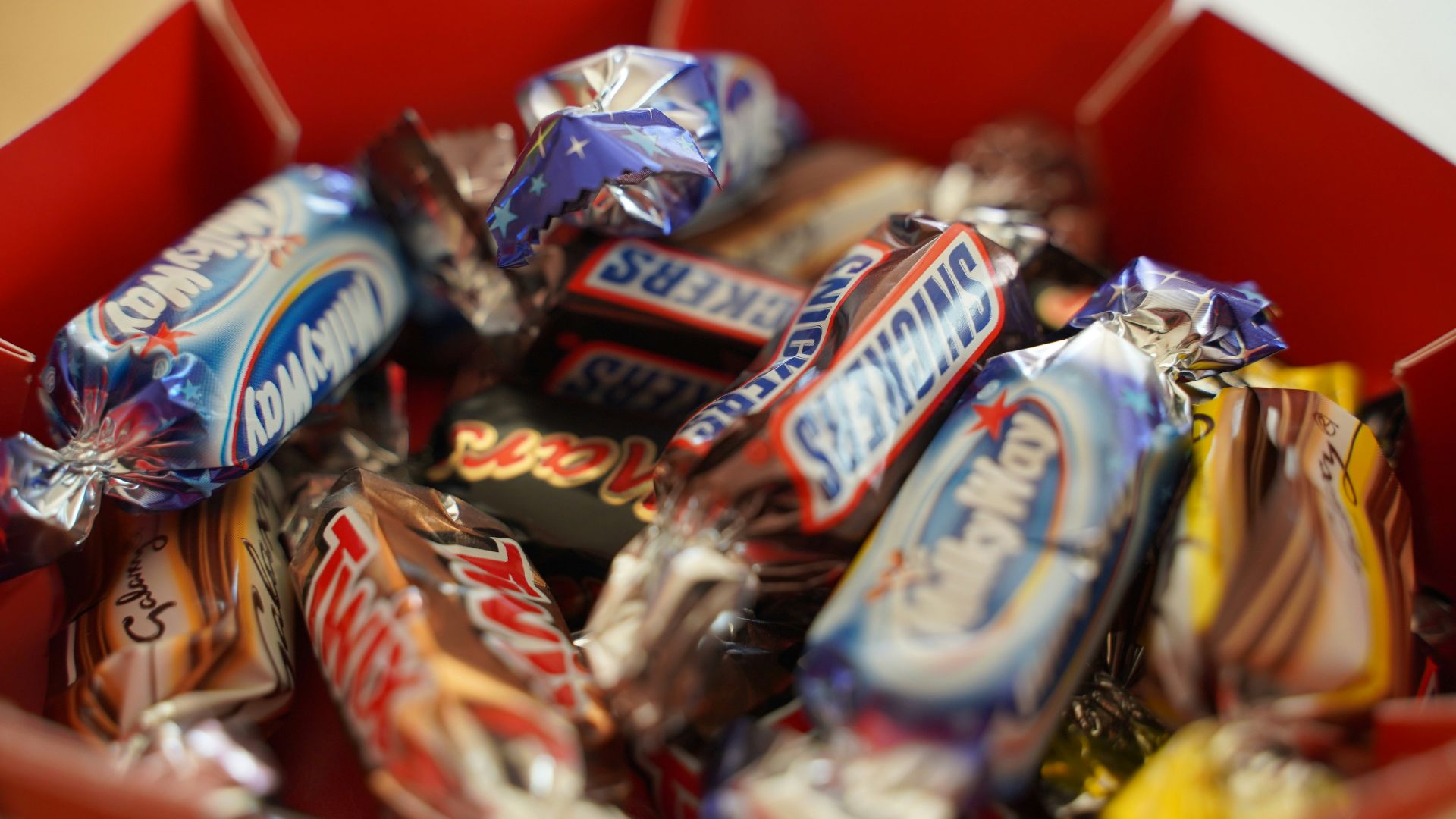 assorted chocolate bar on red shelf