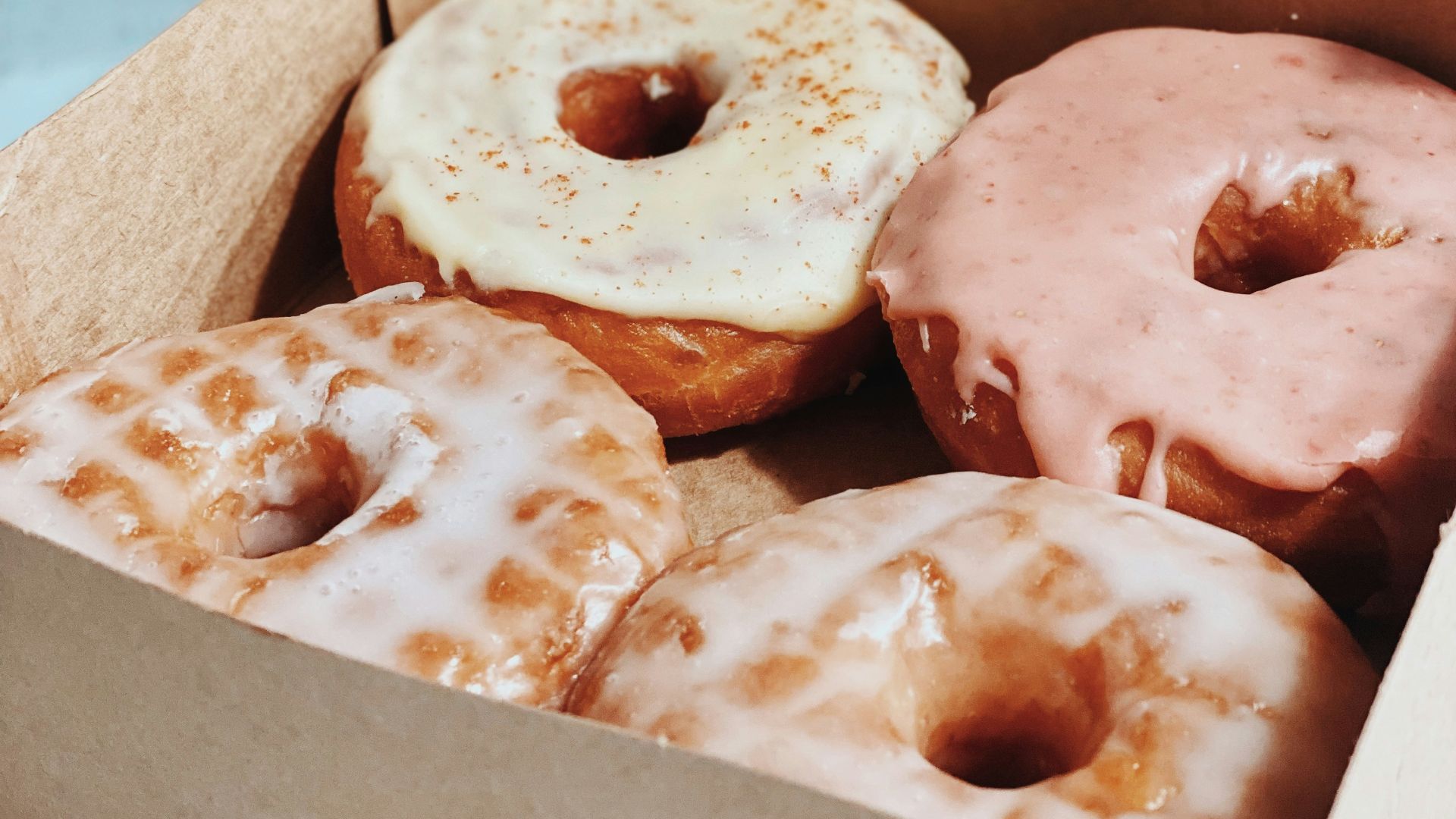 brown and white doughnuts in box