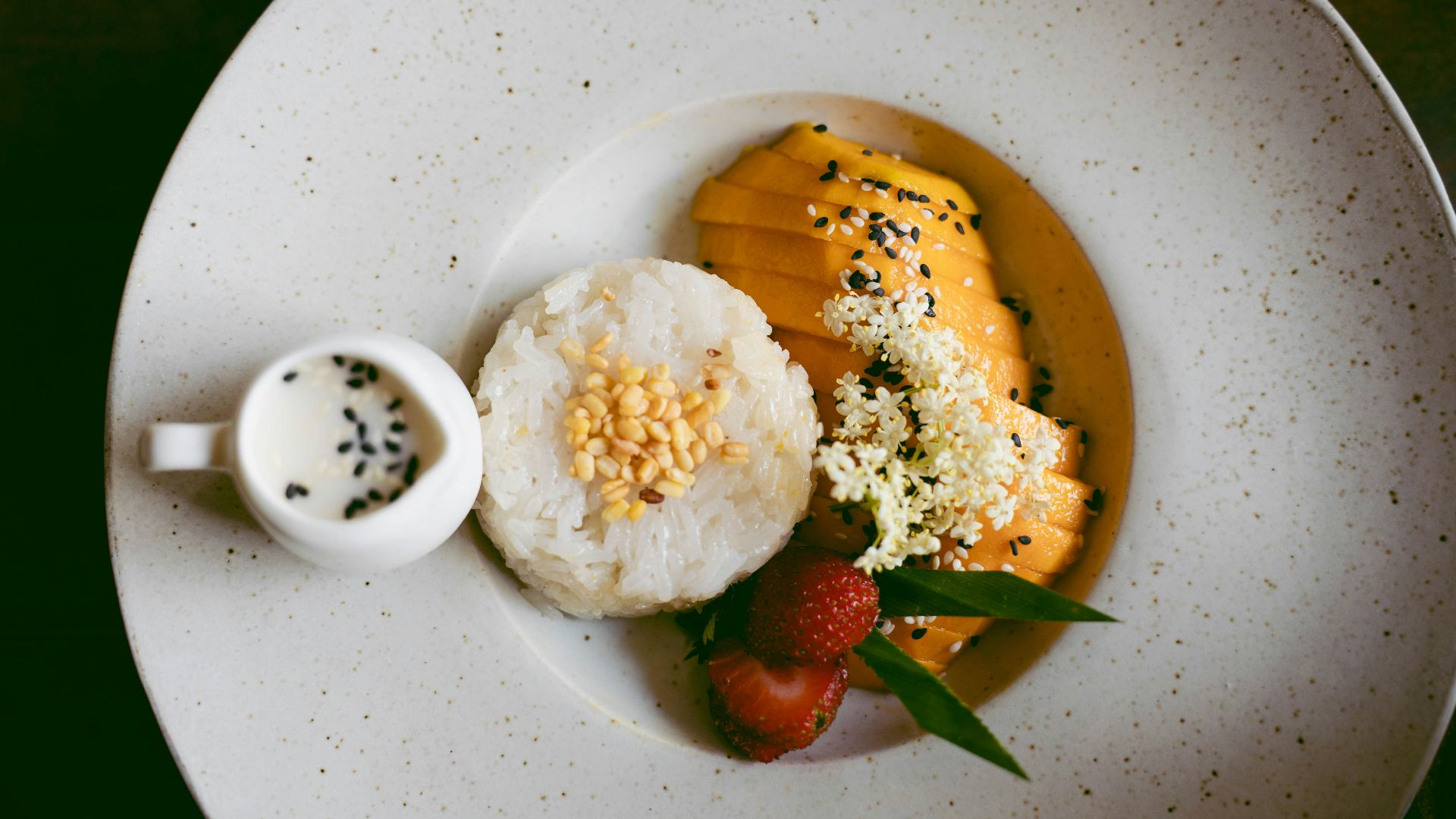 a white plate topped with rice and fruit