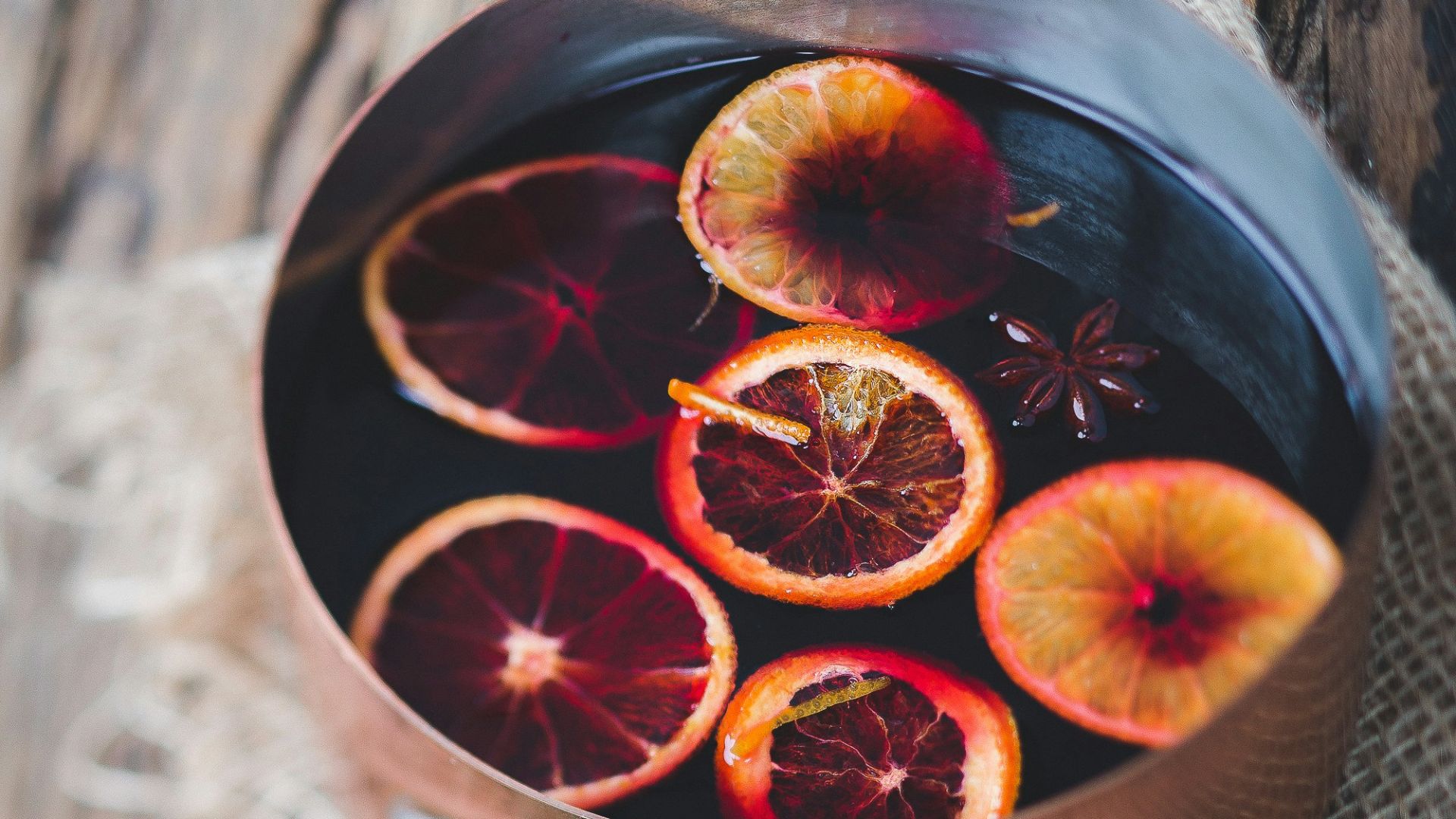 close-up photography of sliced orange fruit on brown cooking pot