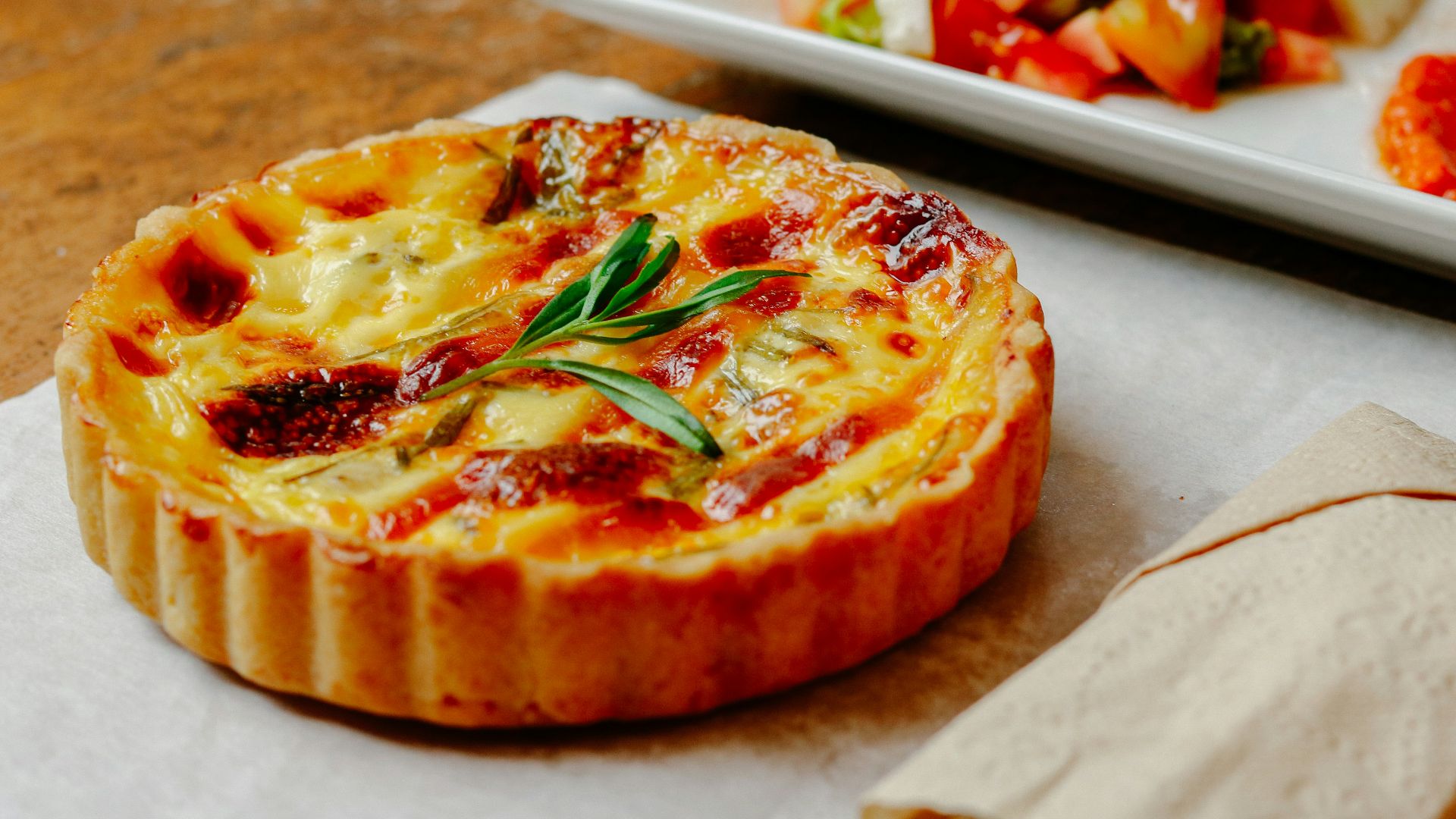 pizza with green leaf on white ceramic tray