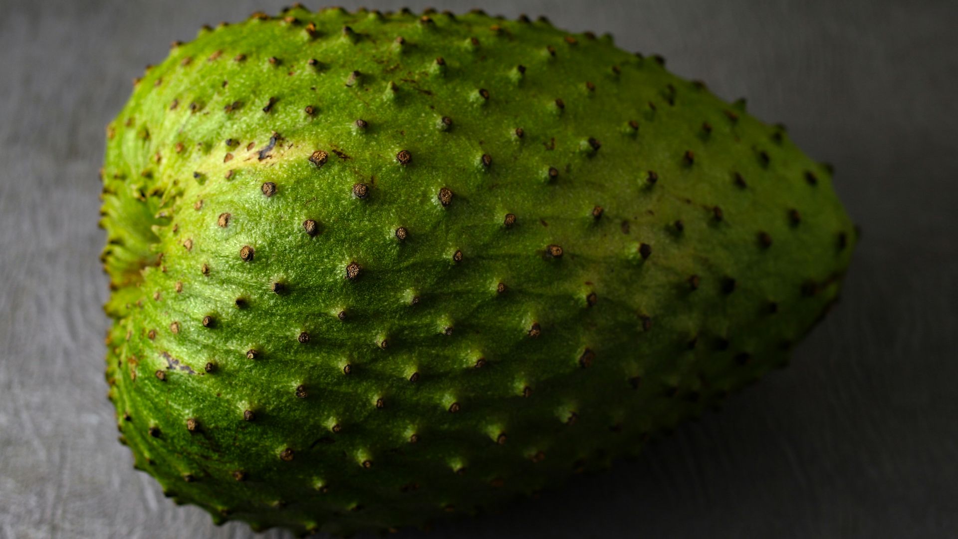 green round fruit on gray textile